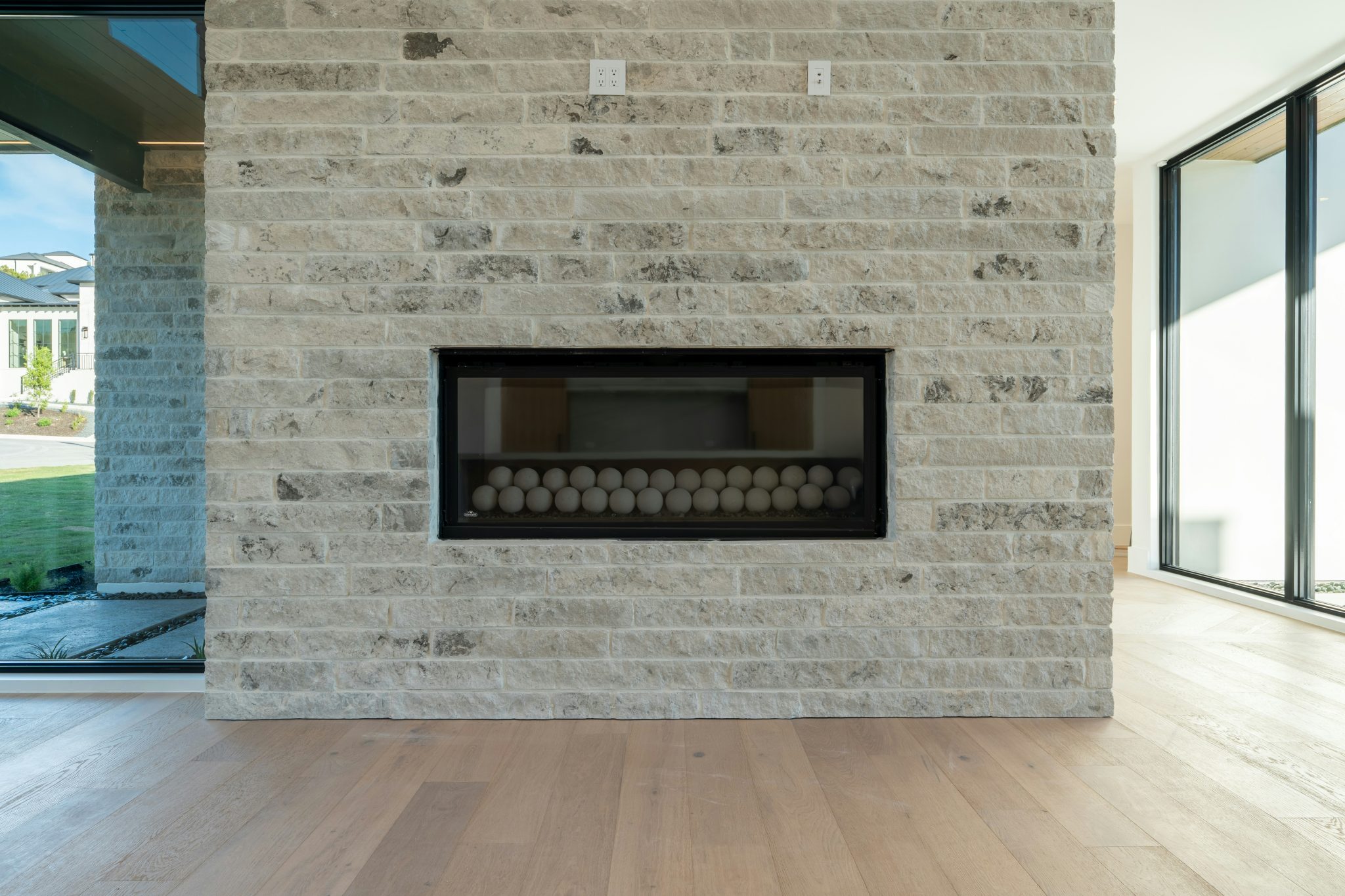 Contemporary fireplace built into a light brick wall