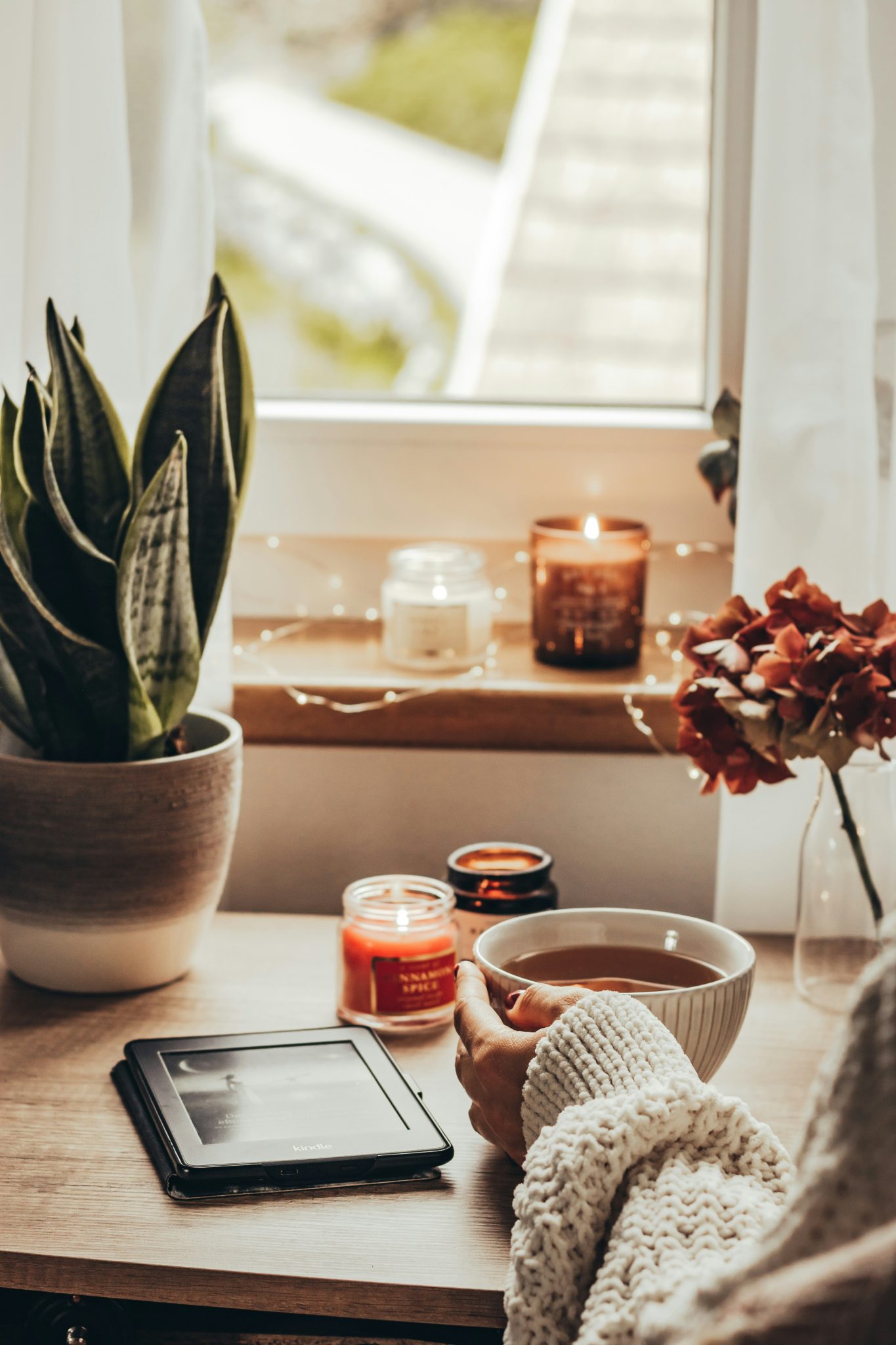 cozy home teatime with book flowers on the window cozy autumn hugge fall aestetic