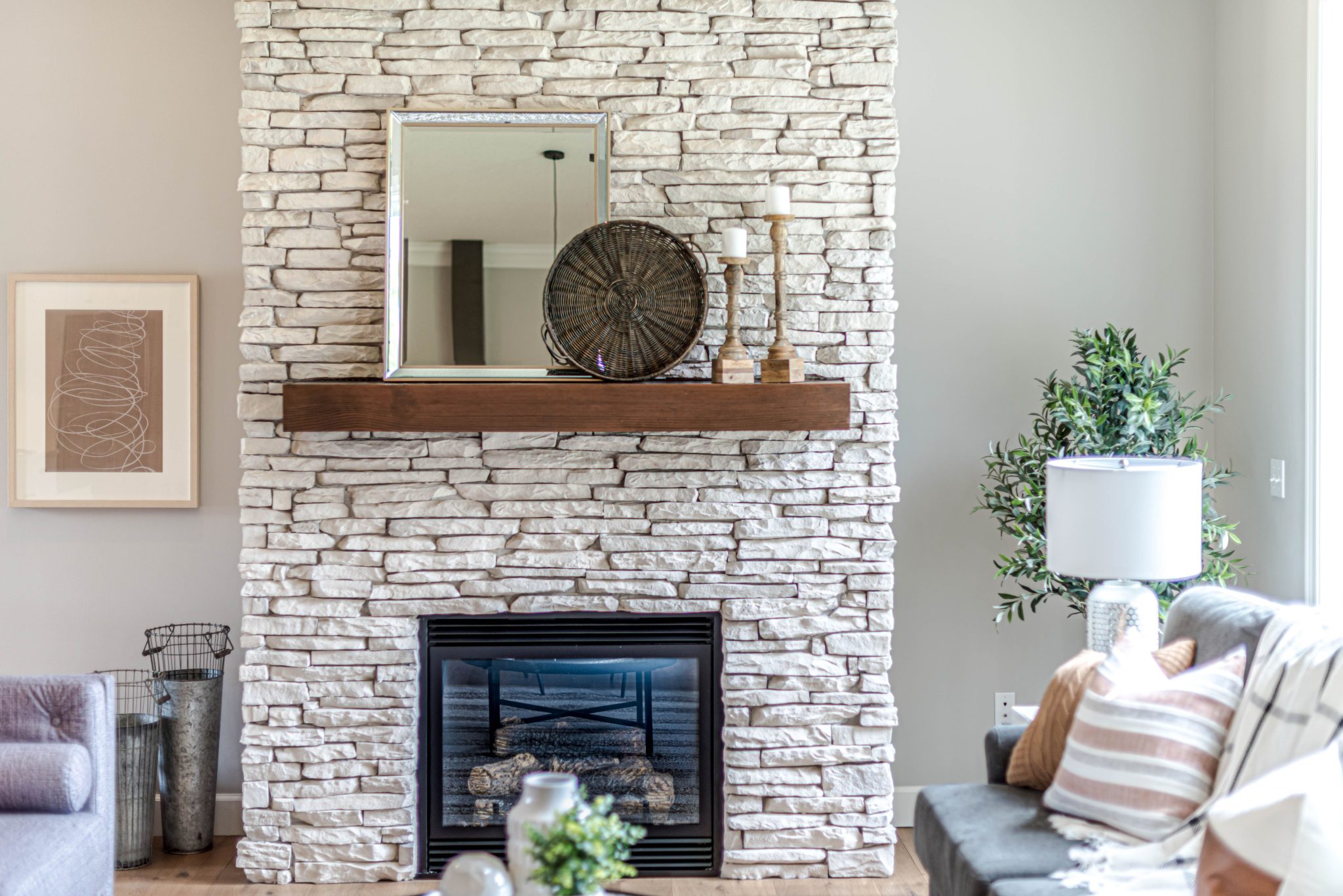 Cozy living room featuring a stylish stone fireplace and elegant decor pieces.
