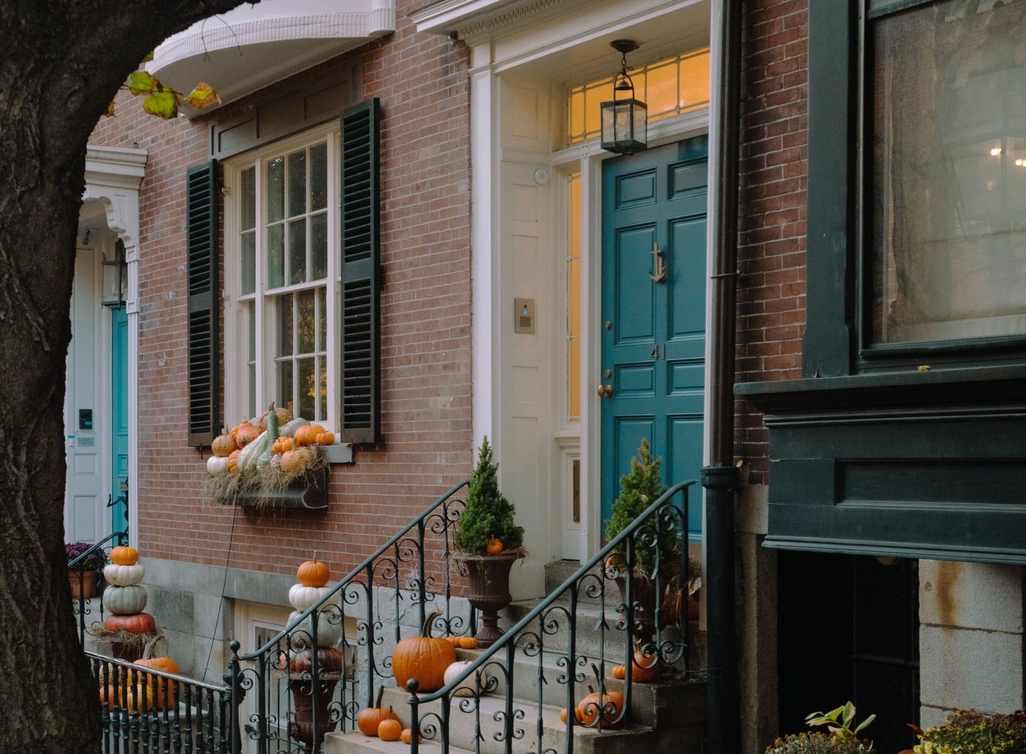 Cozy residential entrance adorned with pumpkins and festive Halloween decorations.