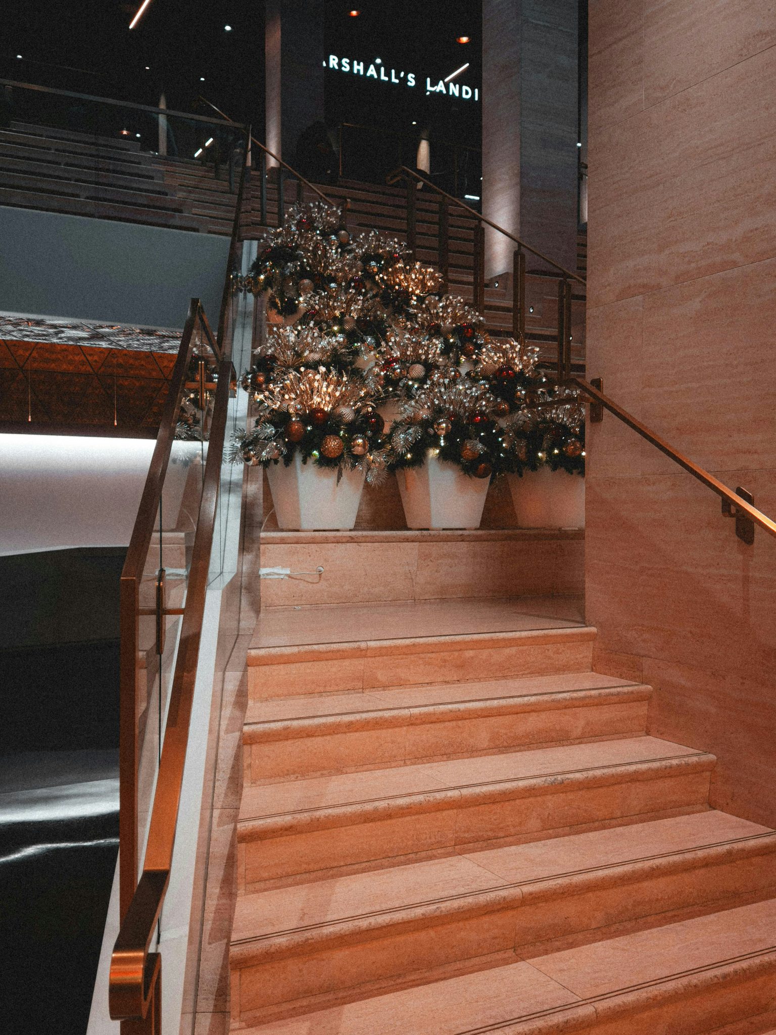 Decorated christmas trees on a marble staircase