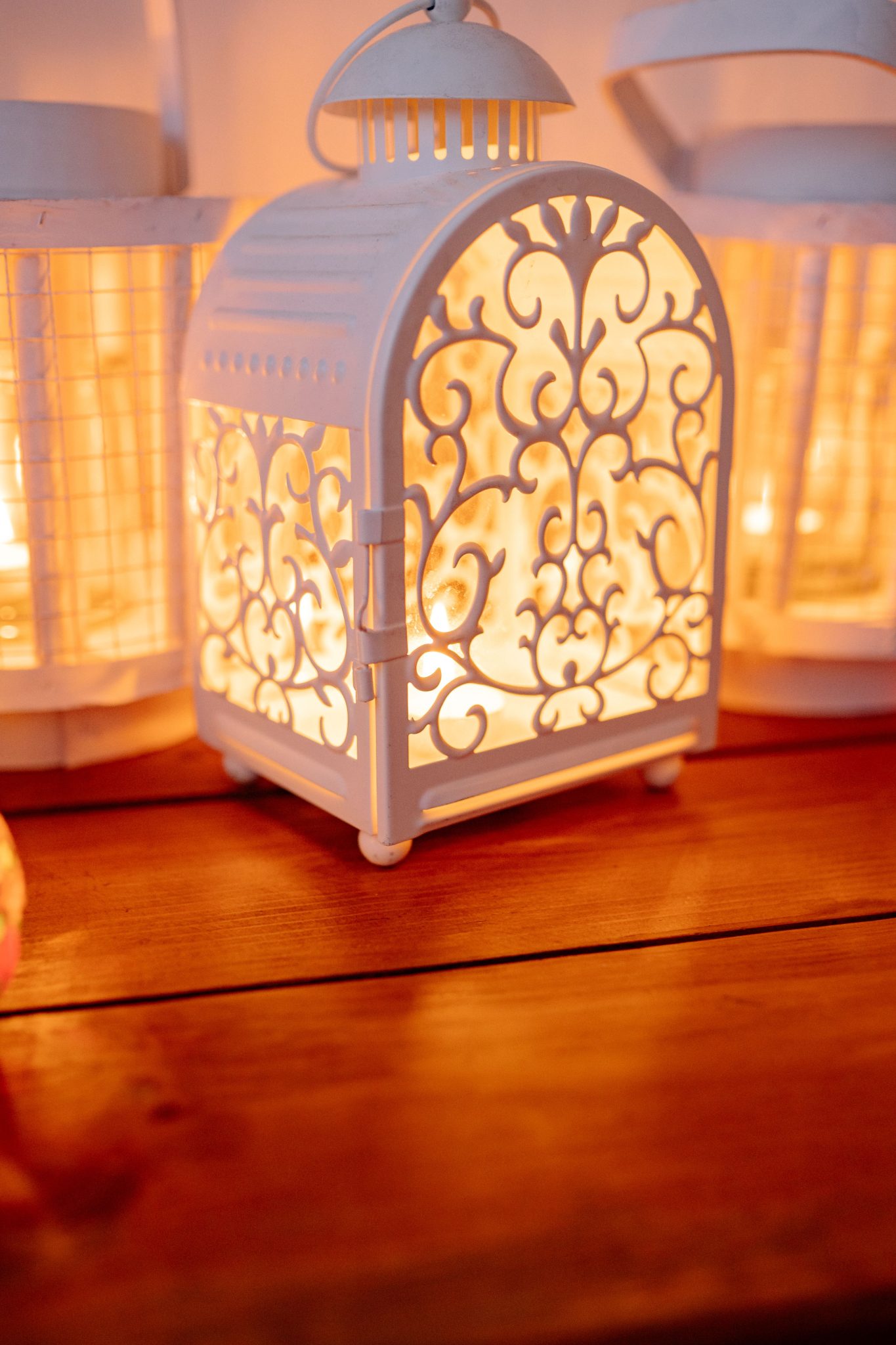 Elegant white lanterns casting warm light, perfect for festive indoor decor.