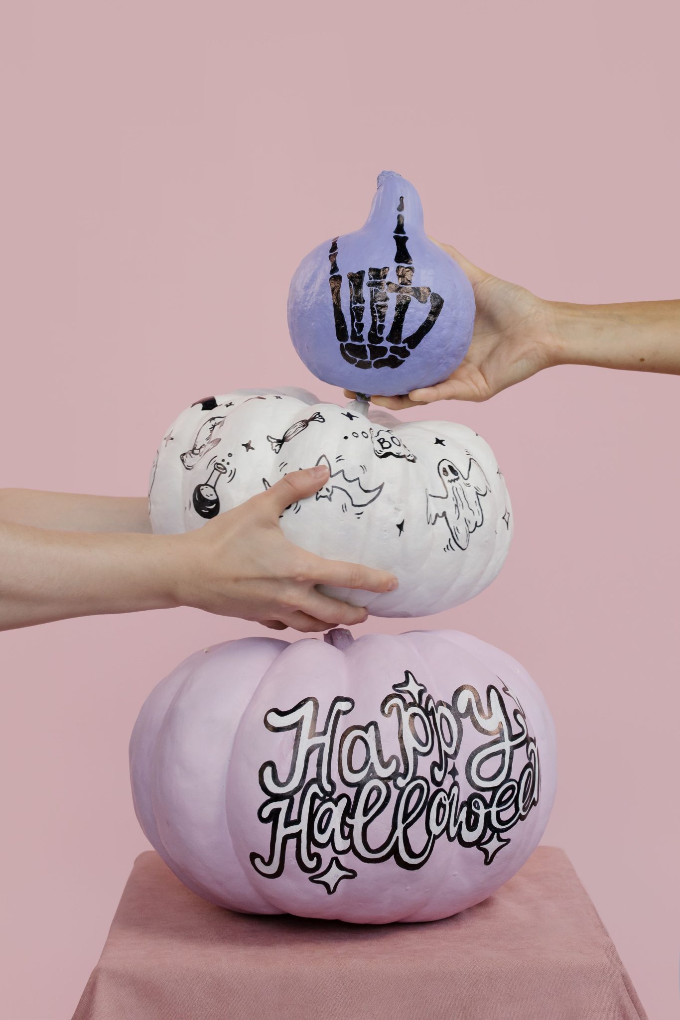 Handmade Halloween pumpkins with unique designs in a creative stacking composition.