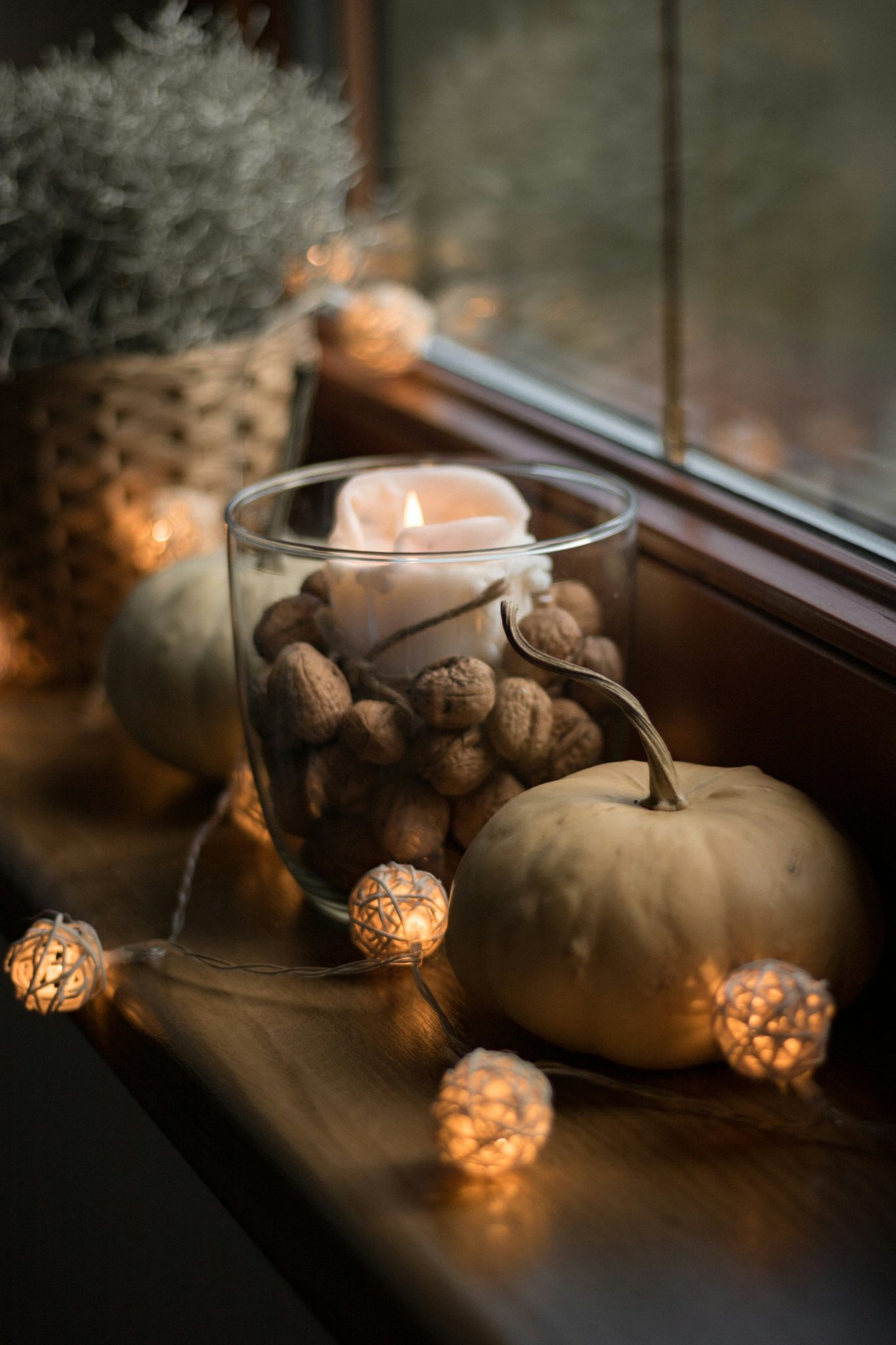 Pumpkin and candle on window