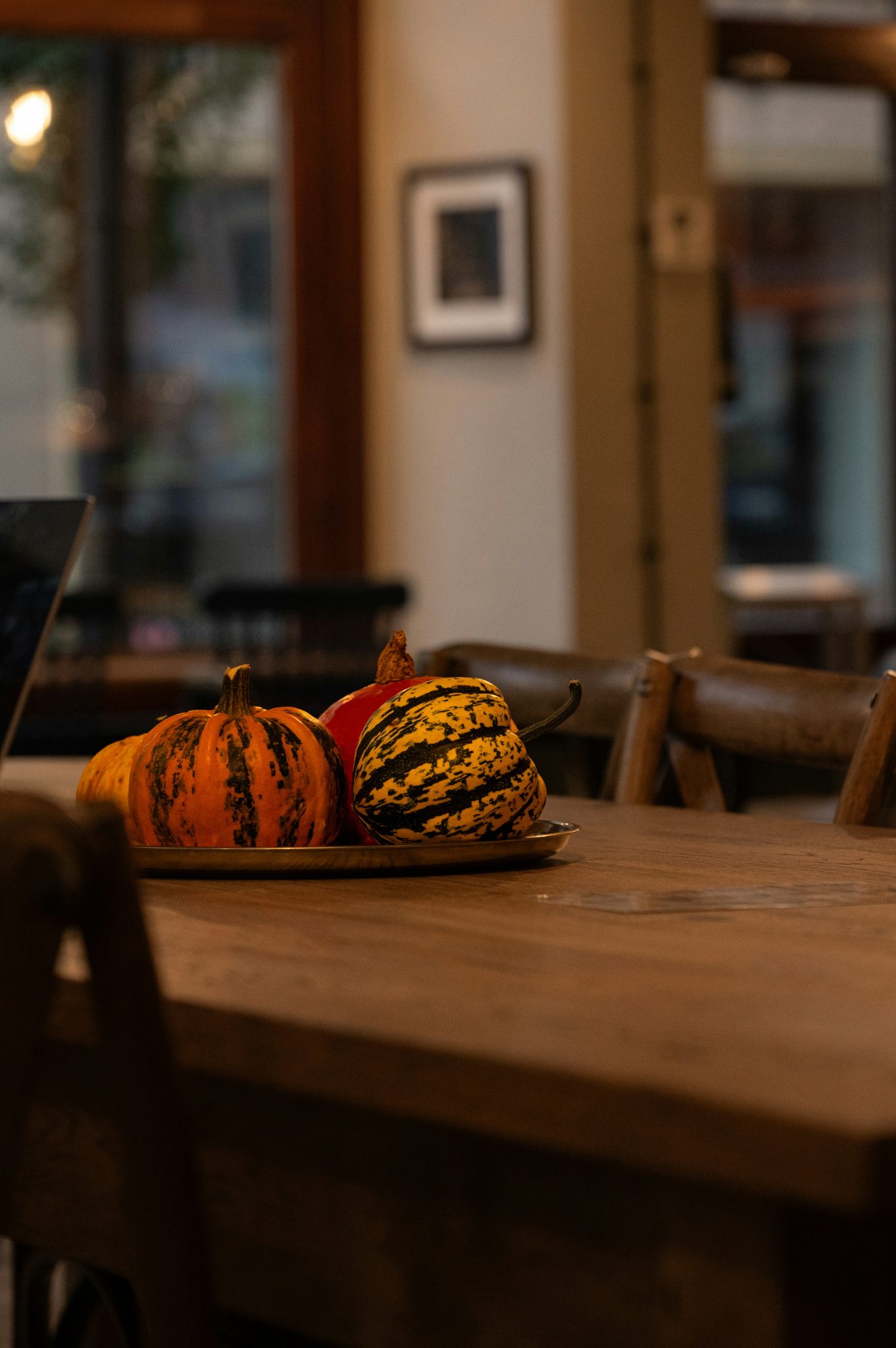 Pumpkins arranged on a wooden table indoors