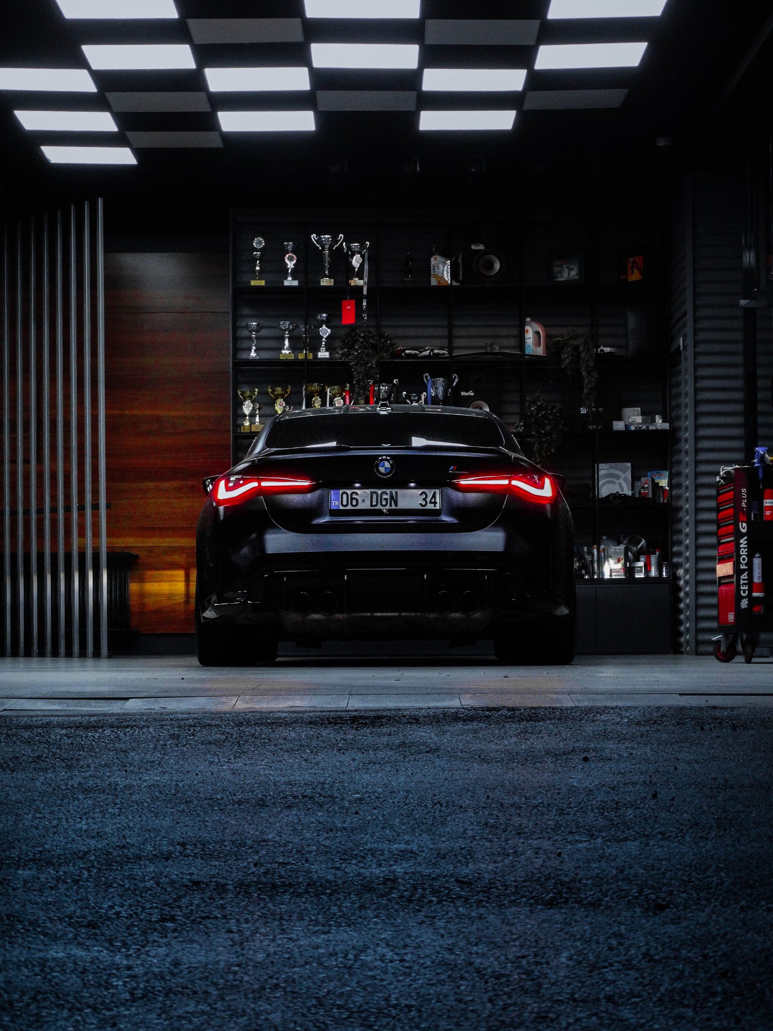 Rear view of a luxury BMW car in a trophy-filled garage in Ankara, Türkiye.