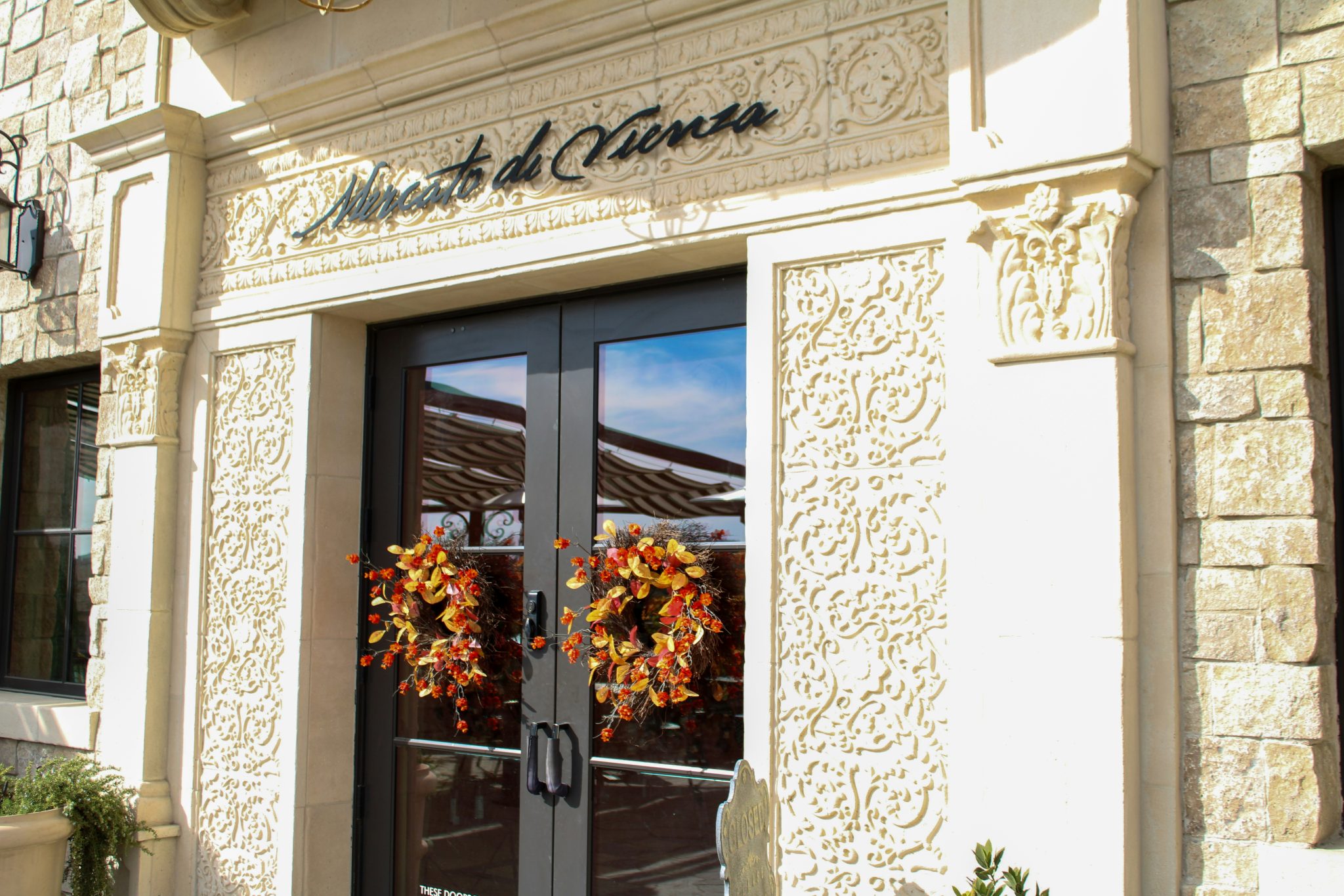 Restaurant entrance with fall wreaths on doors