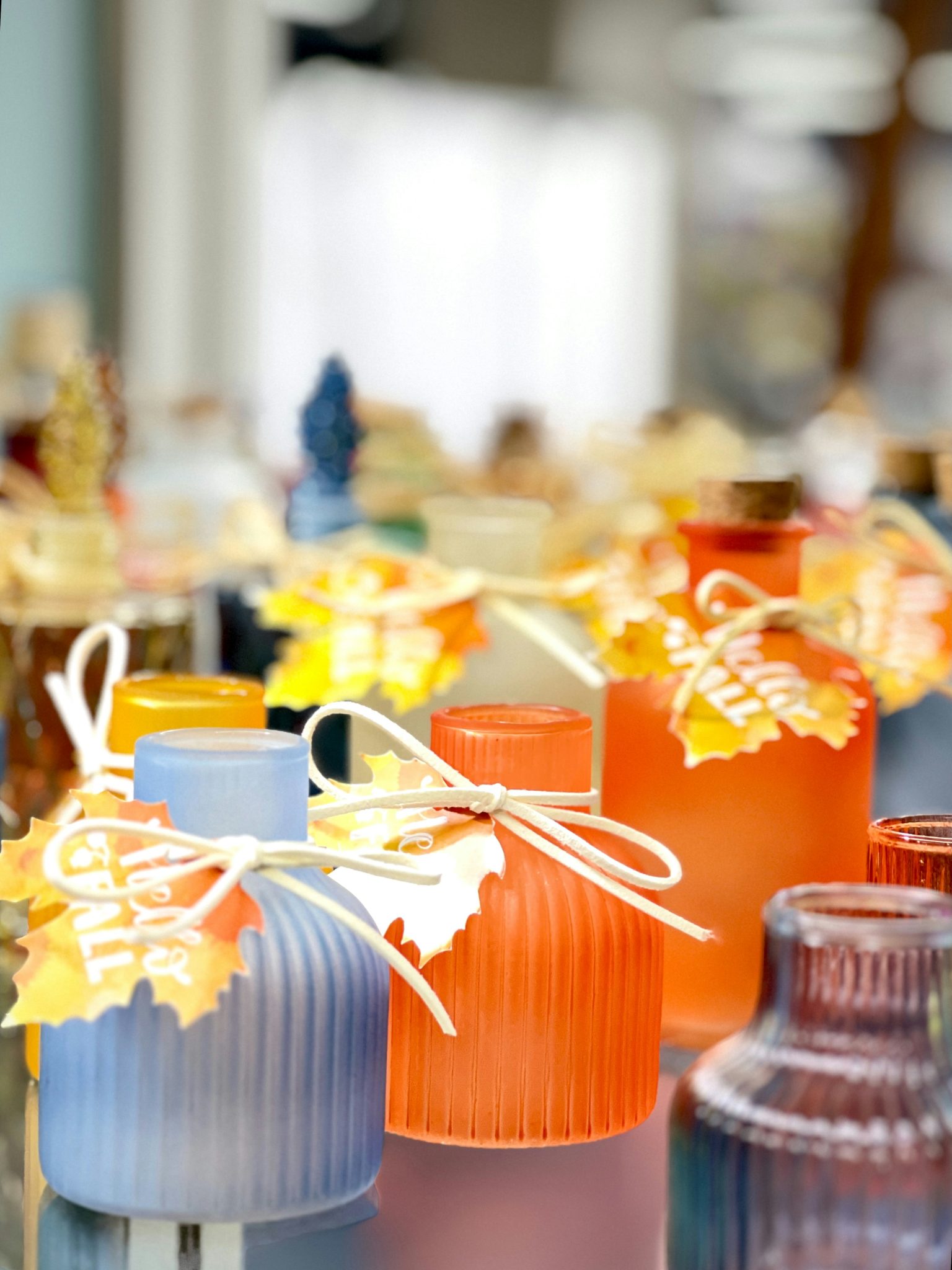 Small decorative bottles with fall leaf tags