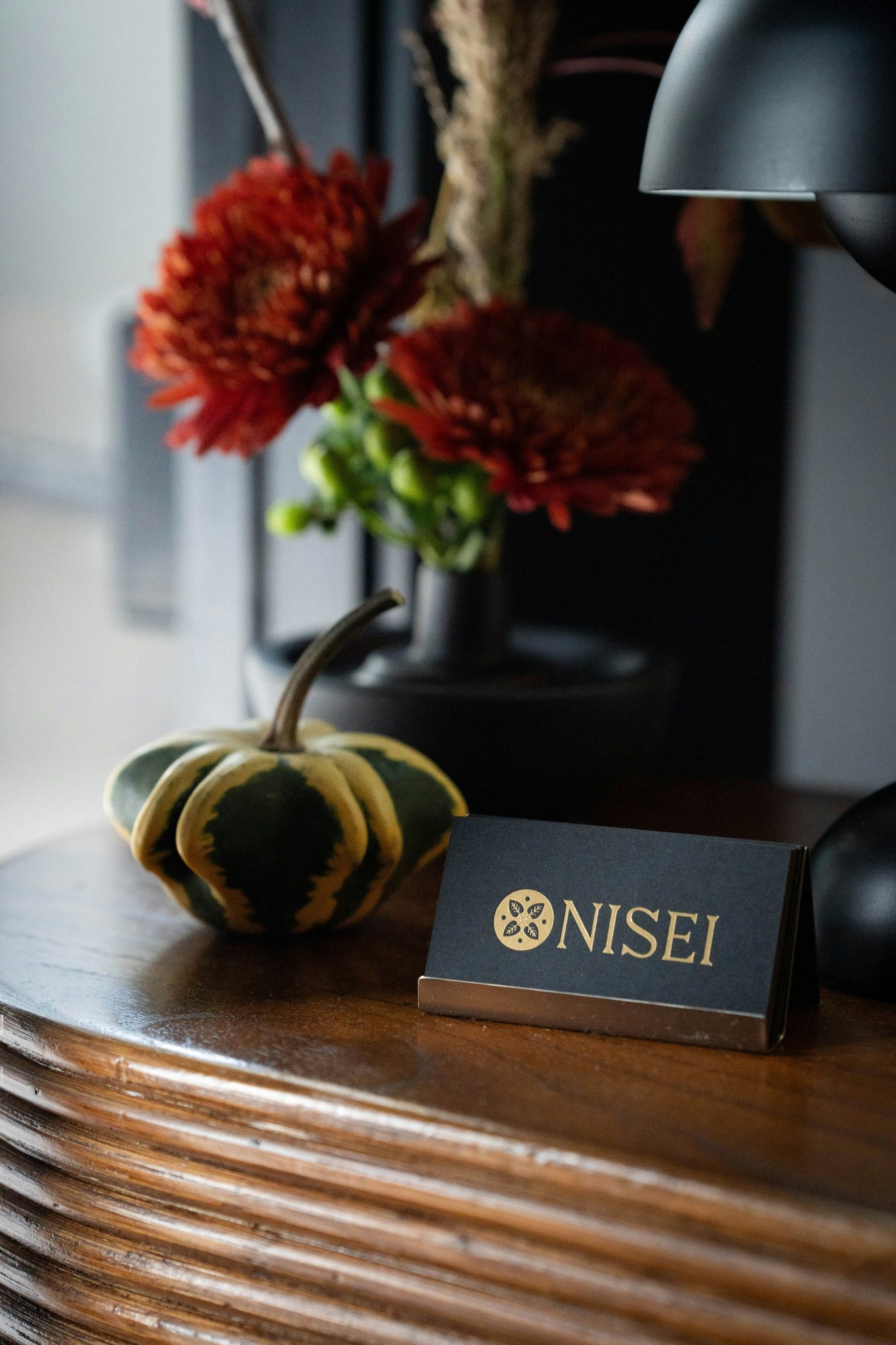 Small decorative gourd and flowers on wooden table