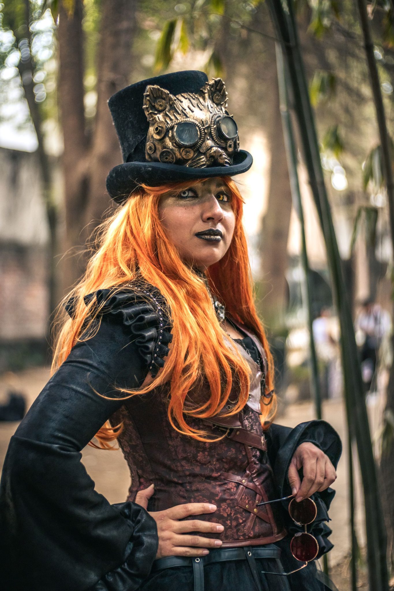 Steampunk woman with gears and hat posing outdoors in Mexico City.