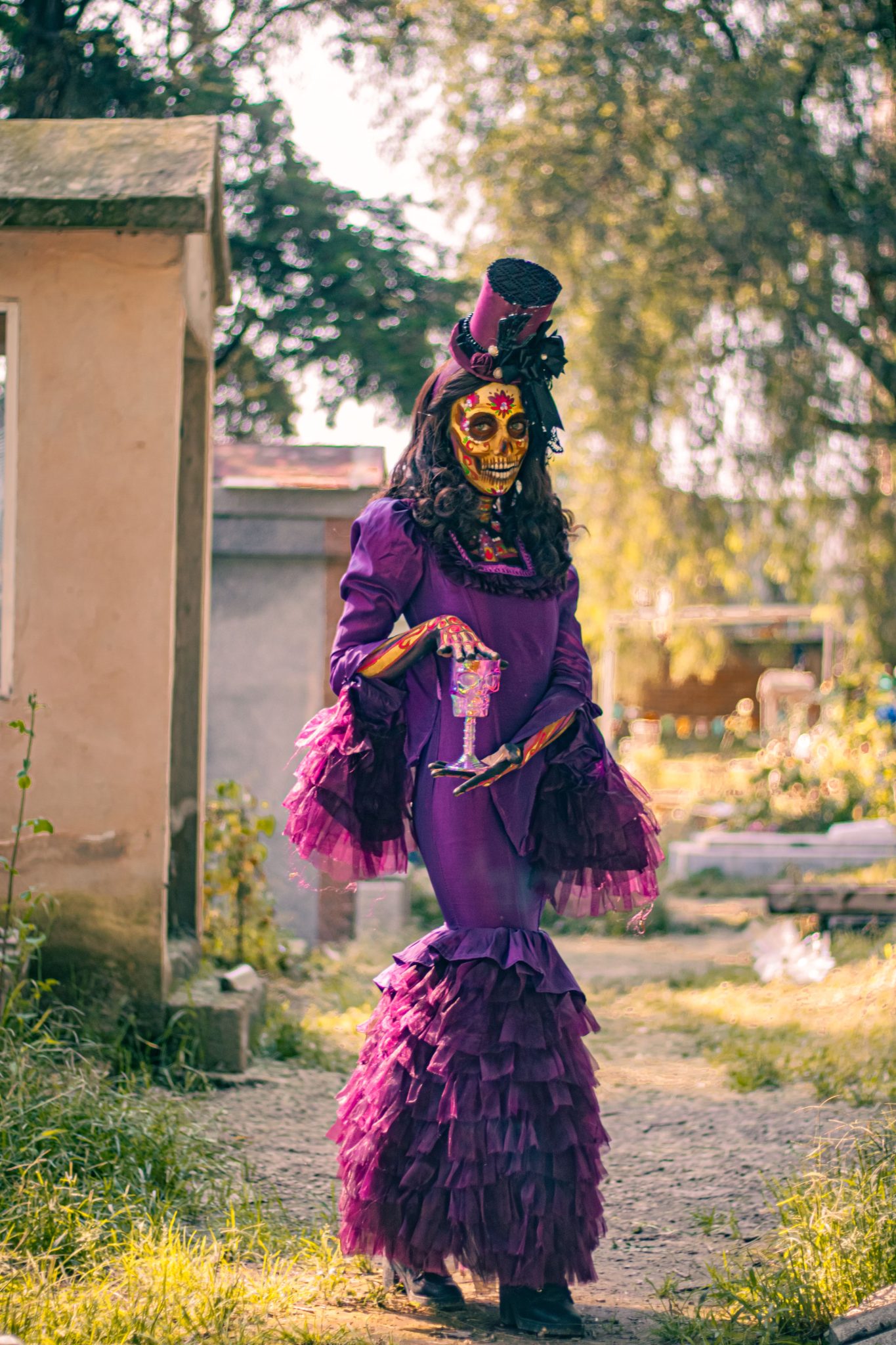 Stylish catrina figure in vibrant costume at Mexico City cemetery for Dia de Muertos.