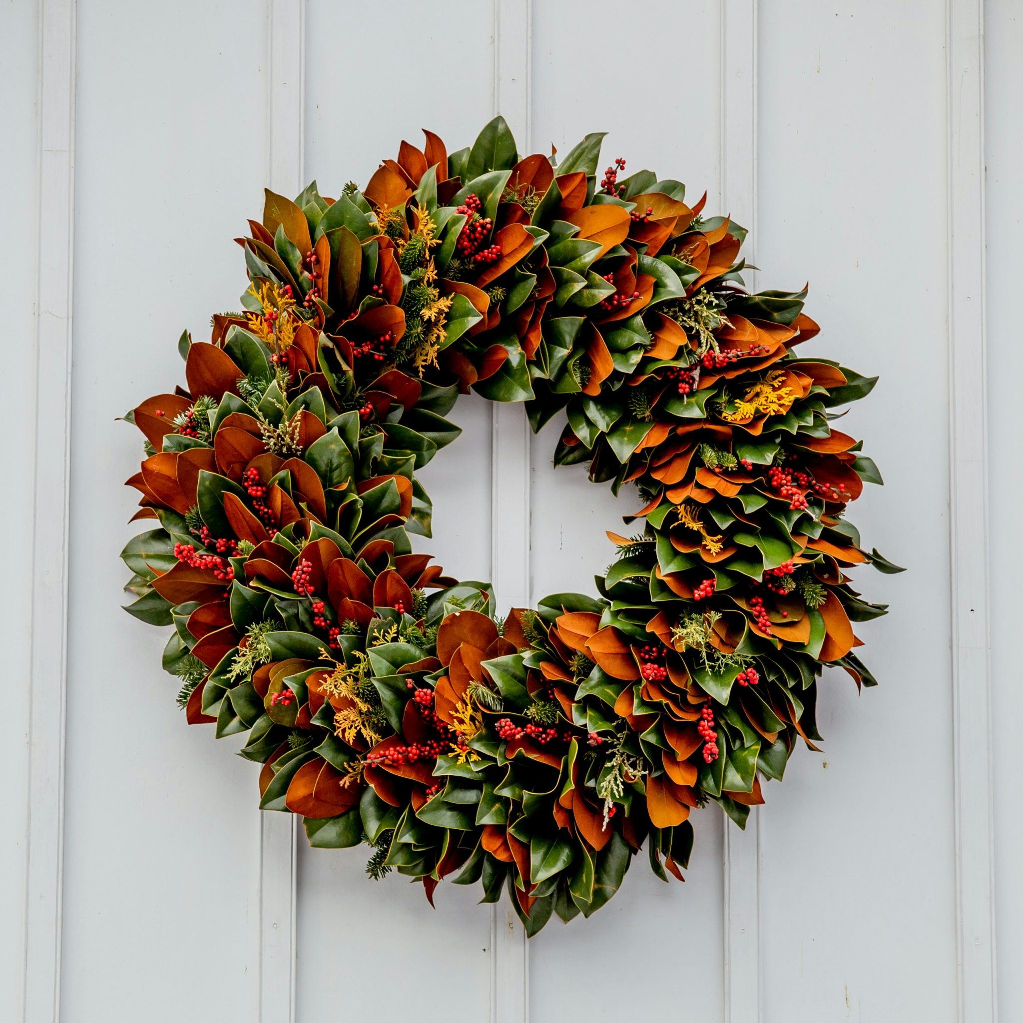 This beautiful wreath is made from all natural items with the focus being magnolia tree leaves turned forward and backwards to create the stunning color composition. Seen at the historic Old City Ceme