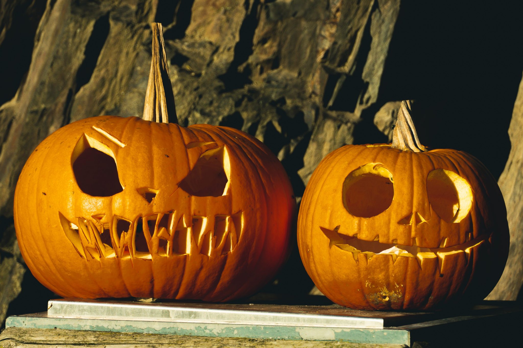 Two carved pumpkins create a spooky Halloween atmosphere, perfect for autumn decorations.