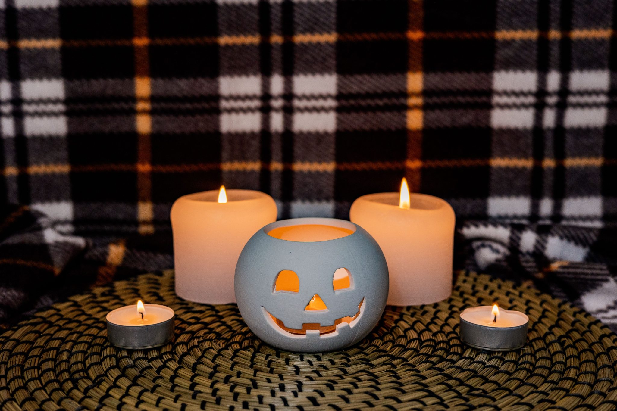 Warm and inviting Halloween setup with a decorative pumpkin and candles.