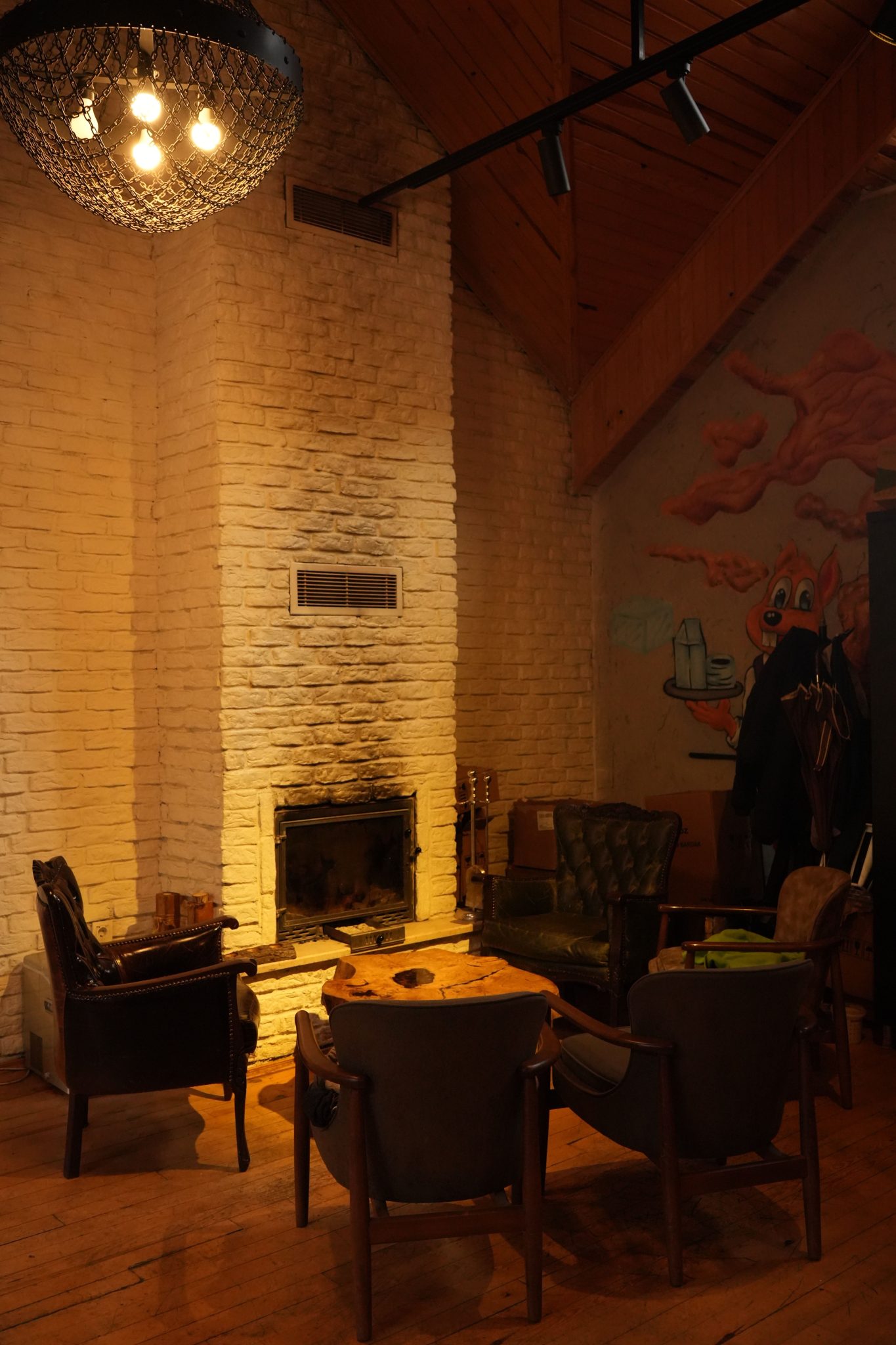 Warm and inviting rustic lounge with brick fireplace and elegant seating.
