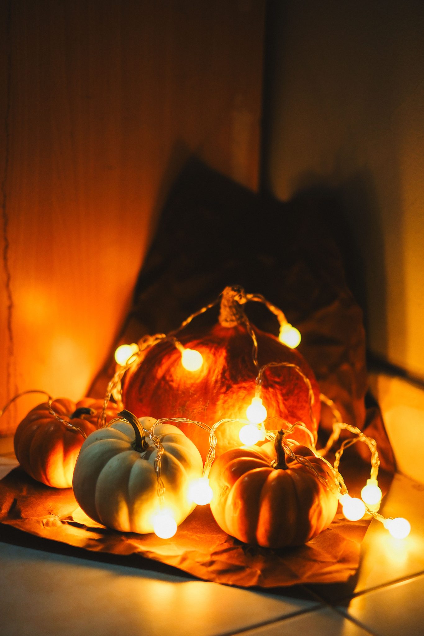 Warm autumn arrangement with illuminated pumpkins creating a cozy ambiance.