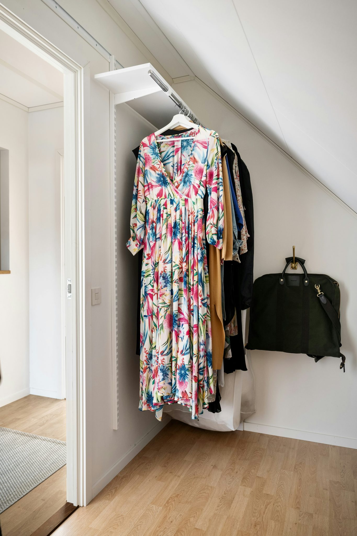 A closet with clothes hanging on a rail