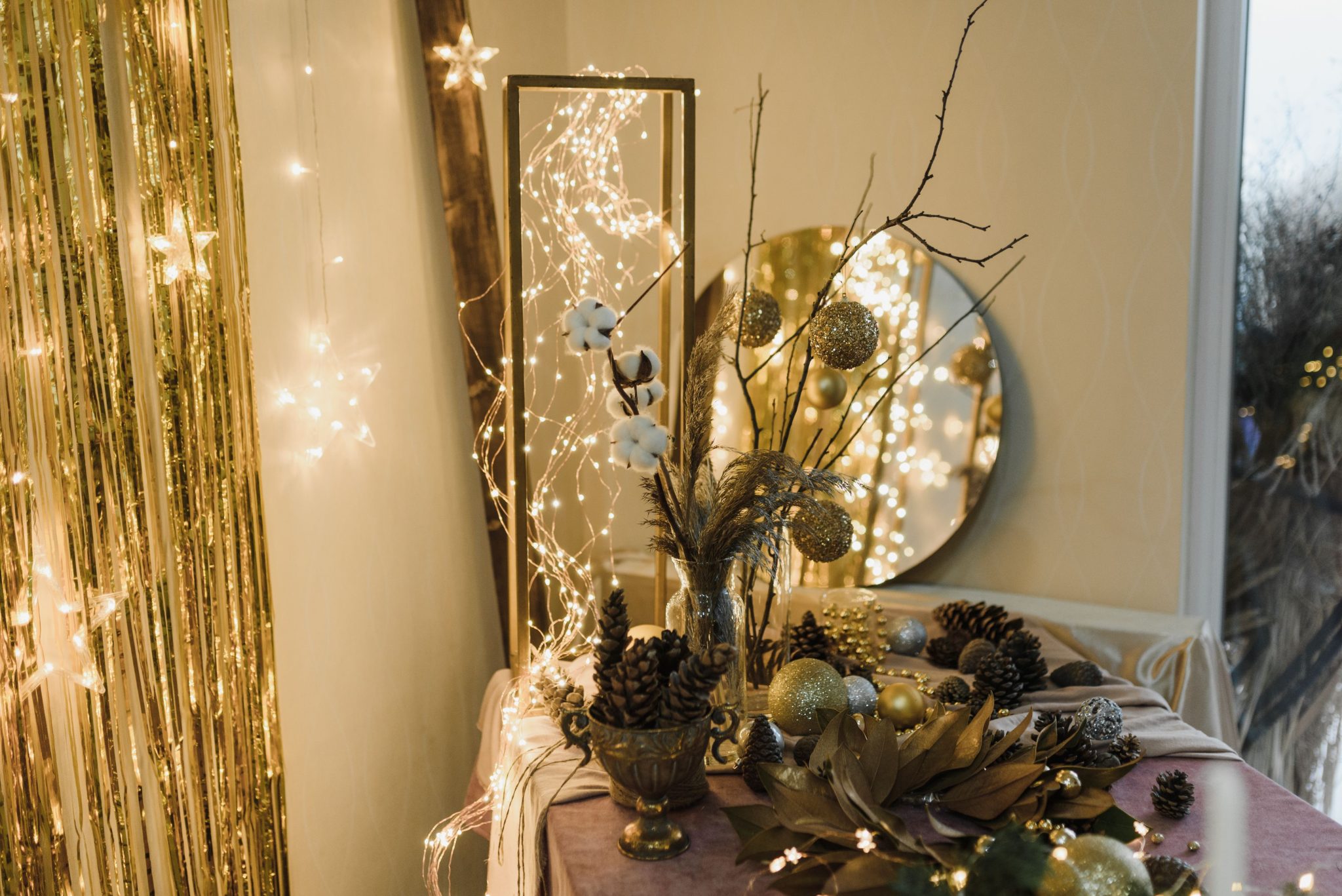 A cozy and elegant Christmas setup with twinkling fairy lights and festive decorations in a home interior.