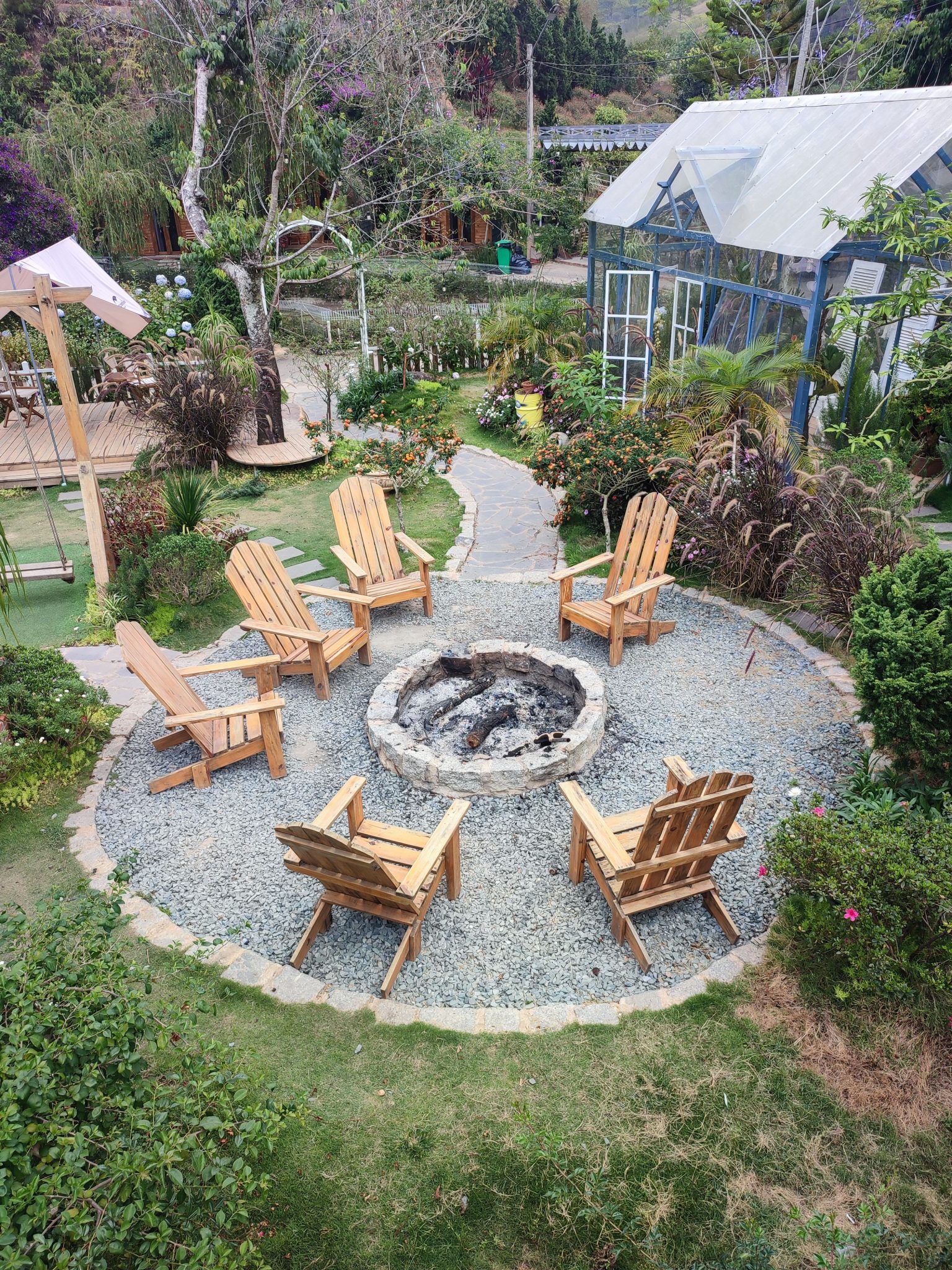 A serene garden setup with a fire pit circle in Đà Lạt, Vietnam.