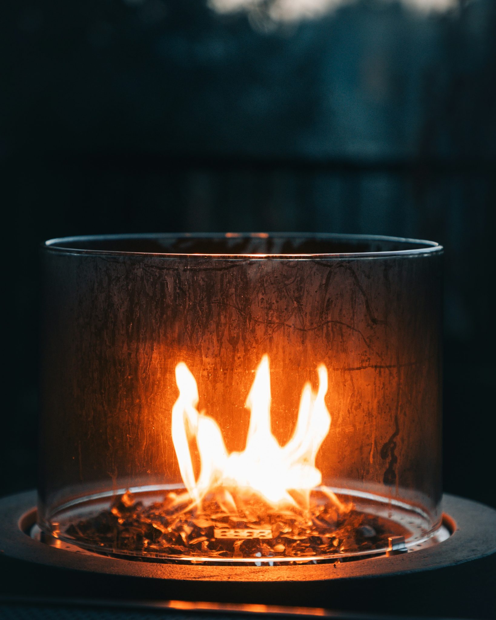 A small fire burning inside a glass enclosure