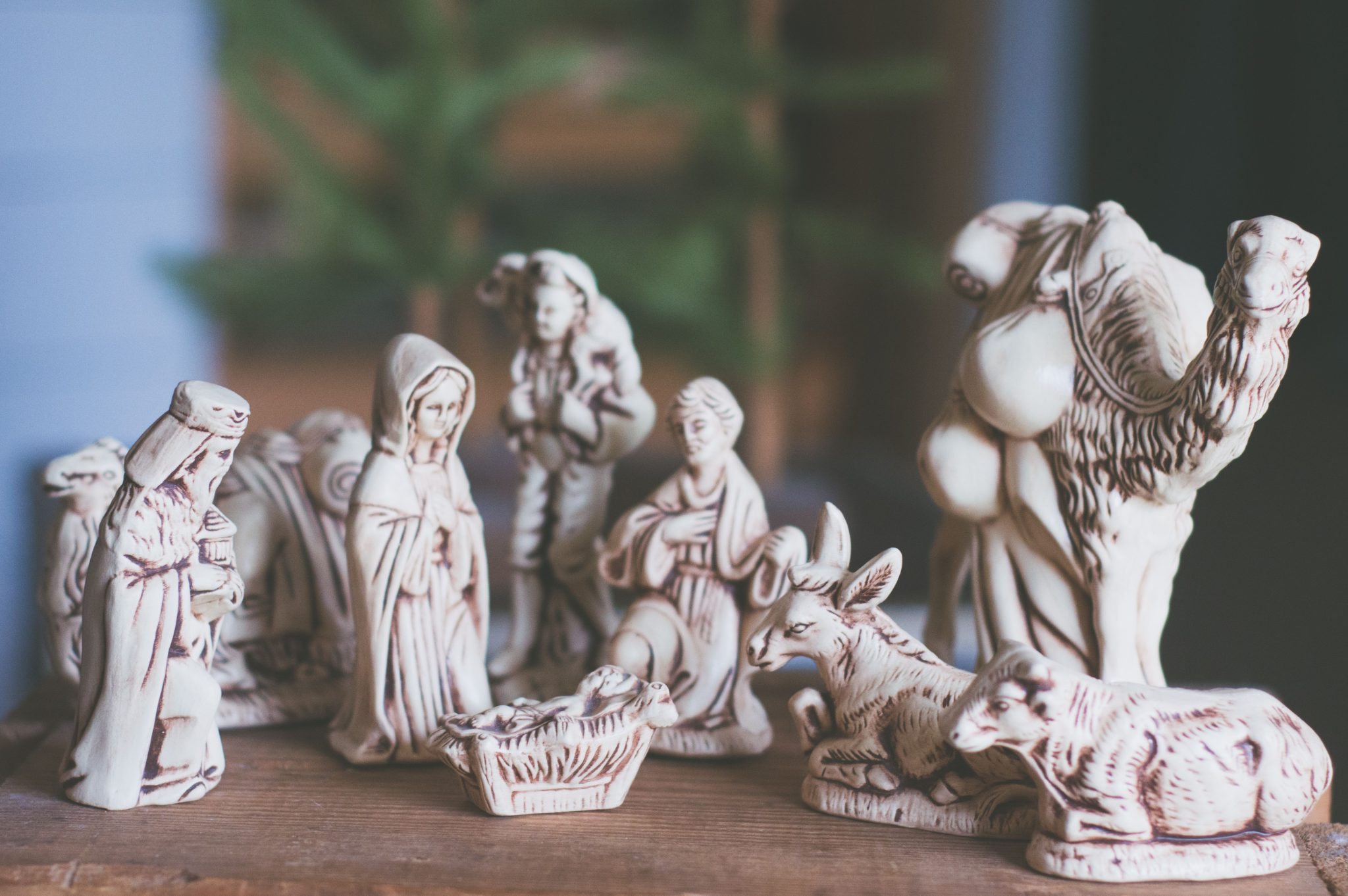 Artistic representation of a nativity scene with detailed figurines and animals.