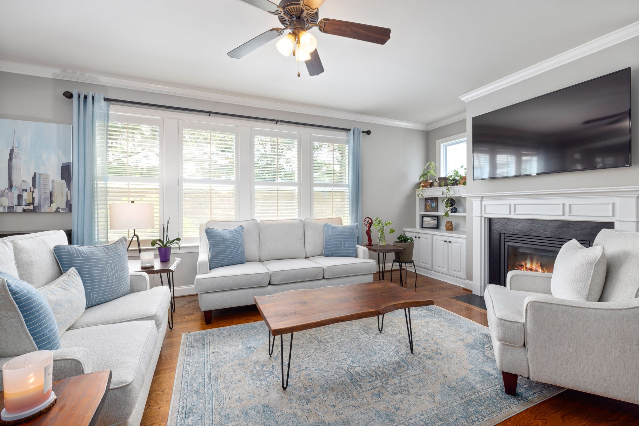 Bright and modern living room interior with fireplace and elegant furniture setup.
