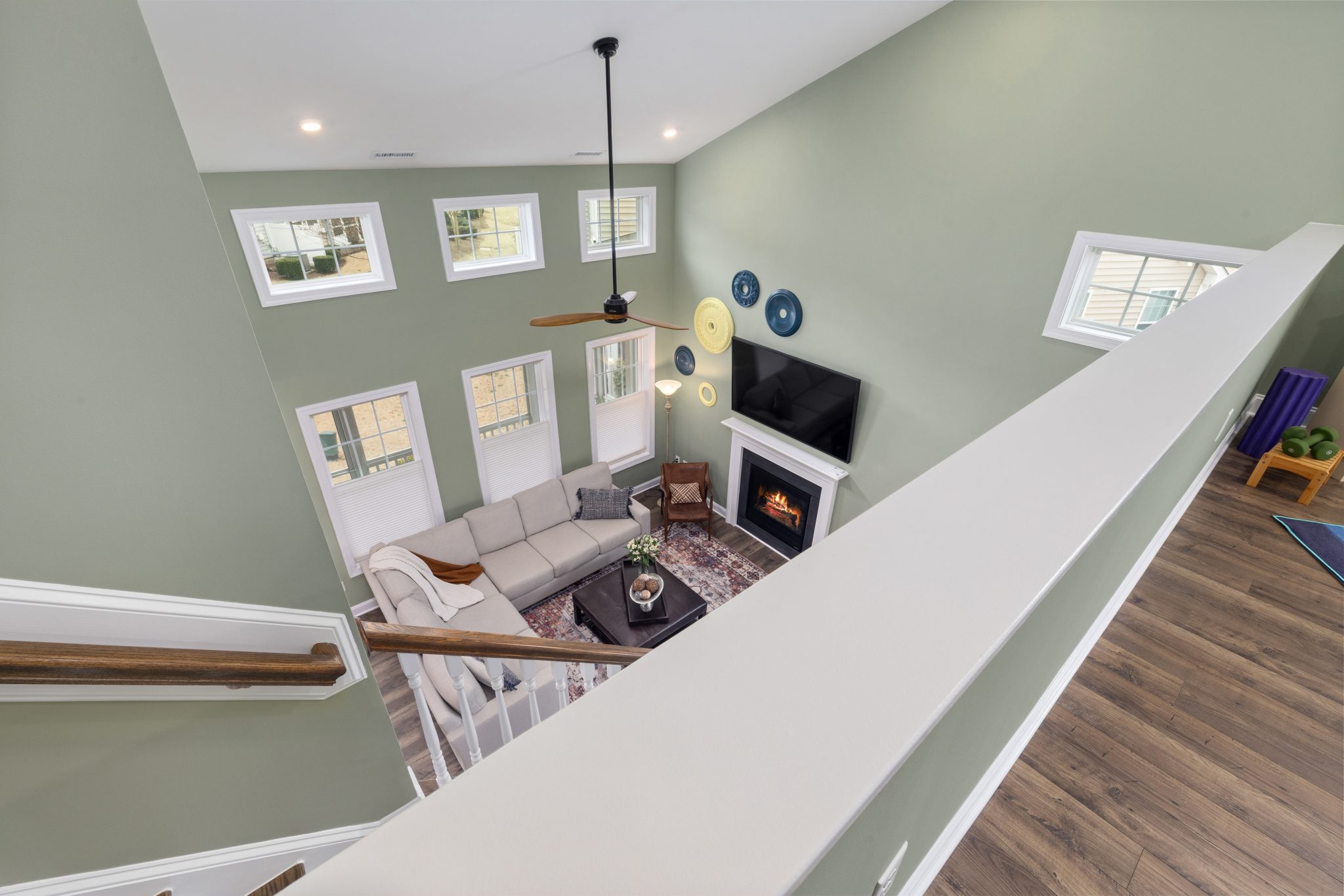 Bright modern living room interior with fireplace viewed from above. Elegant decor and natural light.
