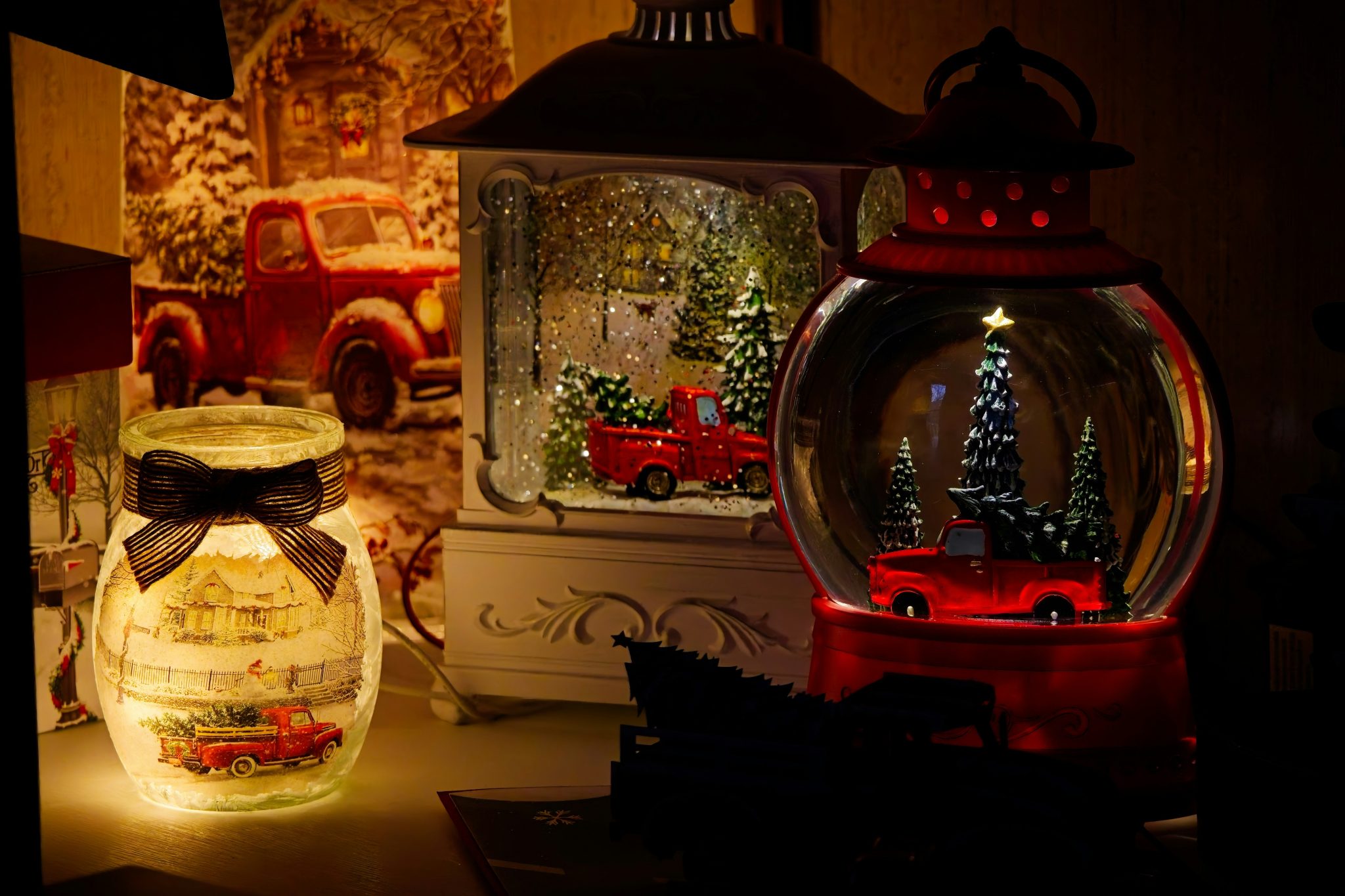 Christmas lanterns with red trucks and trees