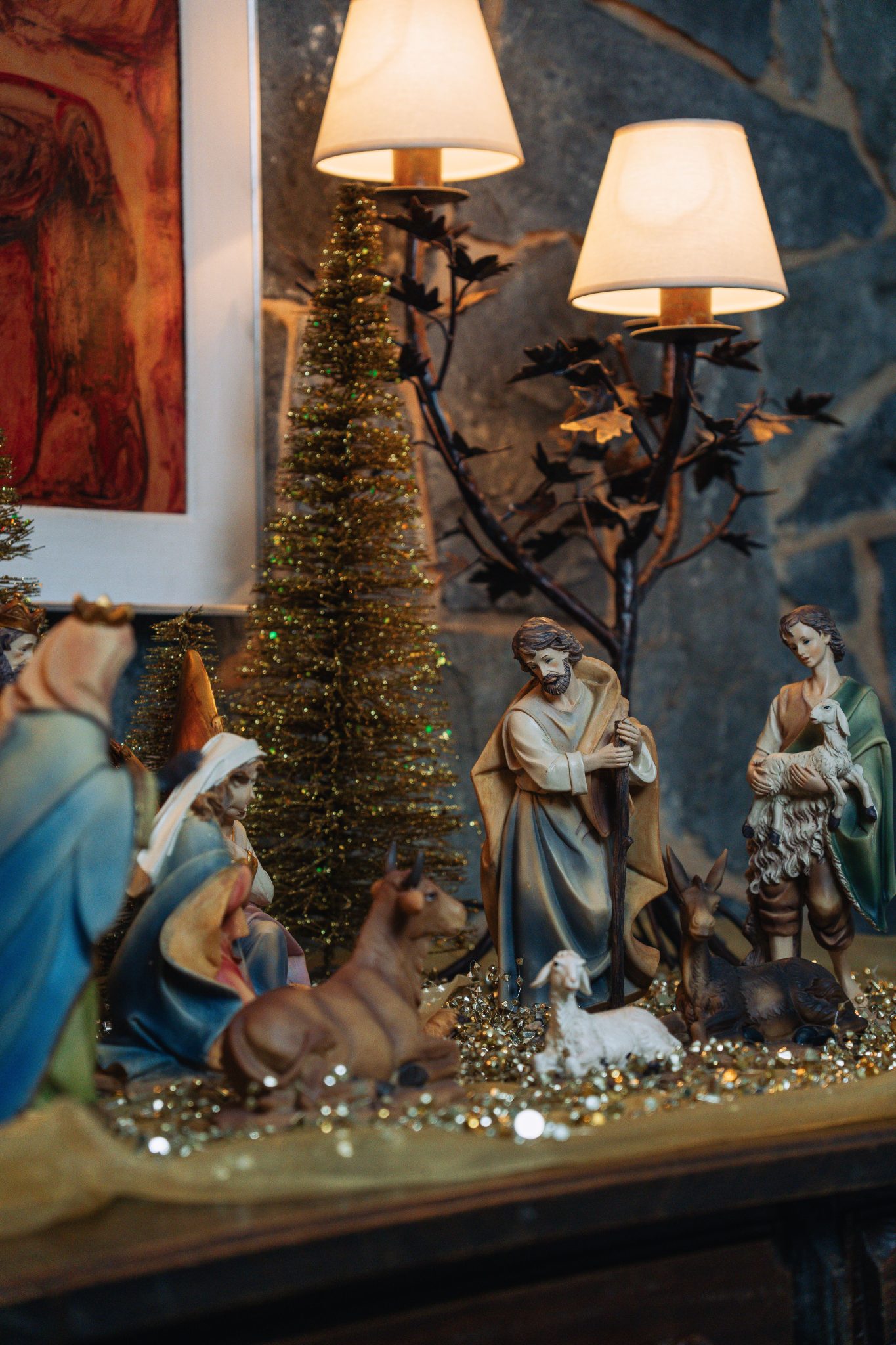 Cozy indoor nativity scene with figurines and festive Christmas decor, capturing holiday warmth.