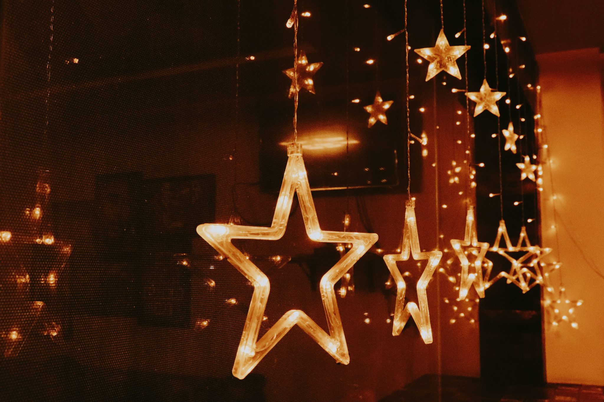 Cozy indoor scene with star-shaped Christmas lights creating a warm ambiance.