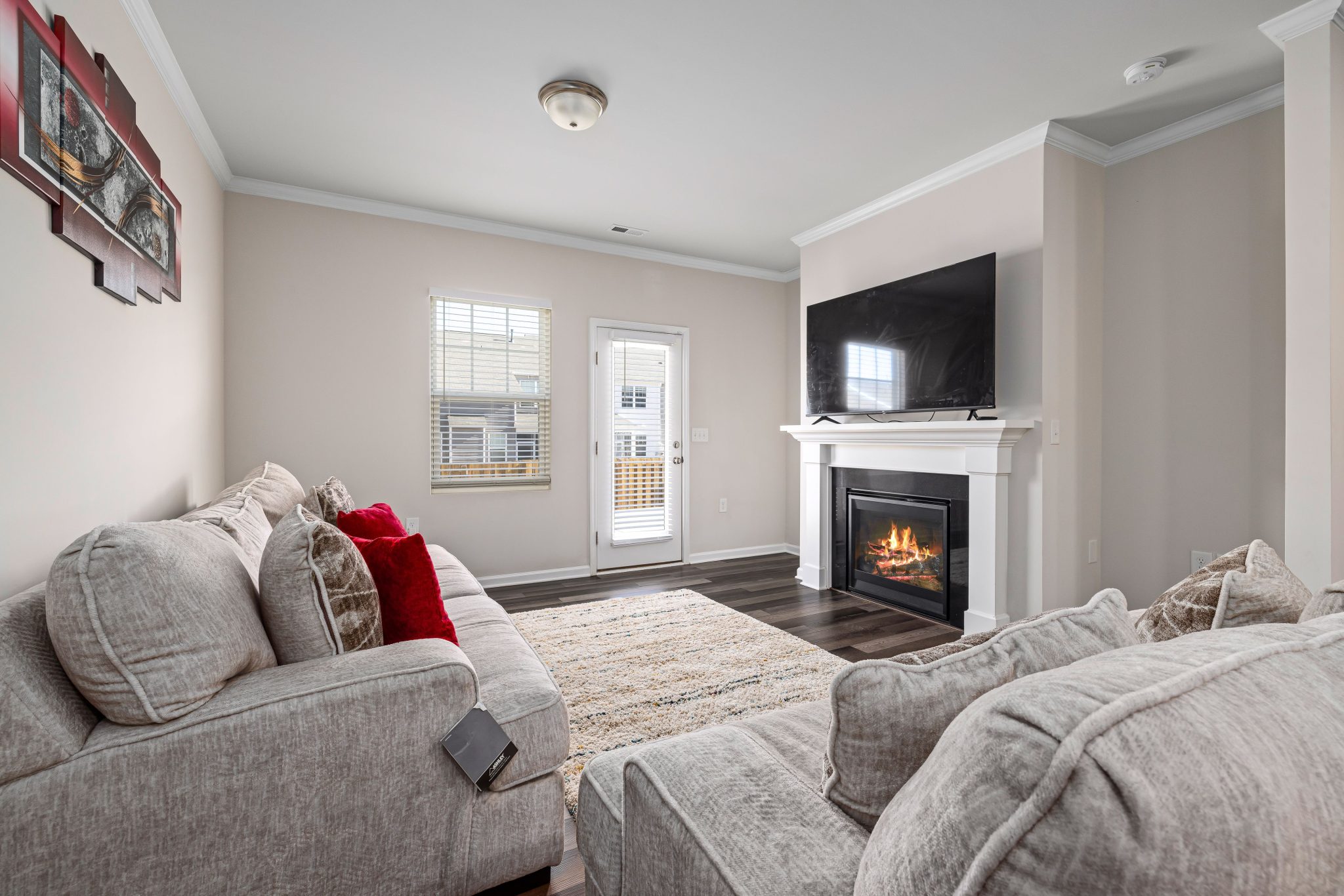 Cozy modern living room featuring a stylish fireplace and large TV for ultimate relaxation.