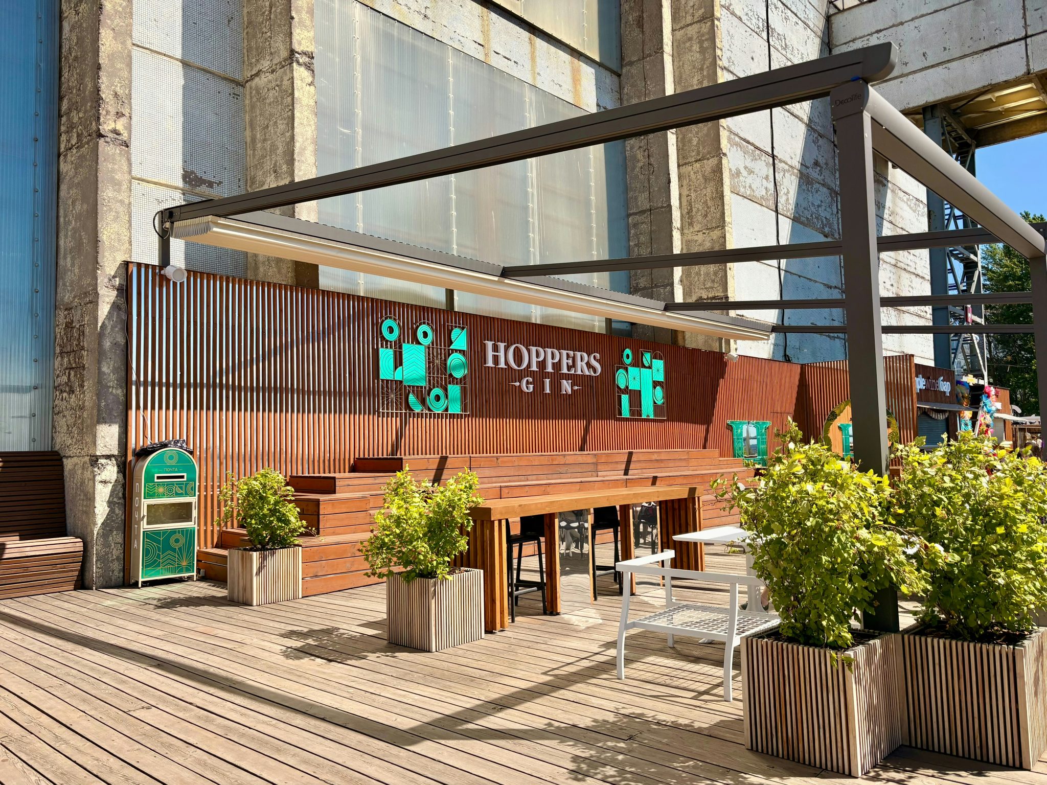 Hoppers outdoor bar with tiered seating and green plants