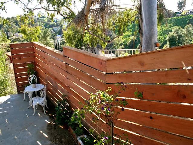 How to Build a Horizontal Plank Fence in a Hillside Backyard | HGTV