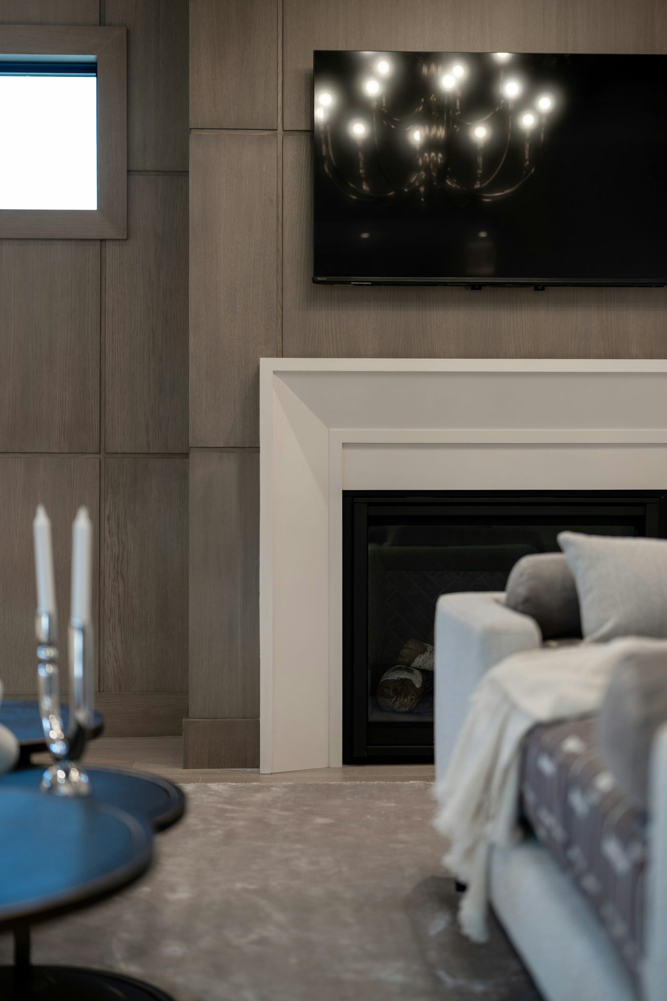 Modern living room with fireplace, tv, sofa, and candles