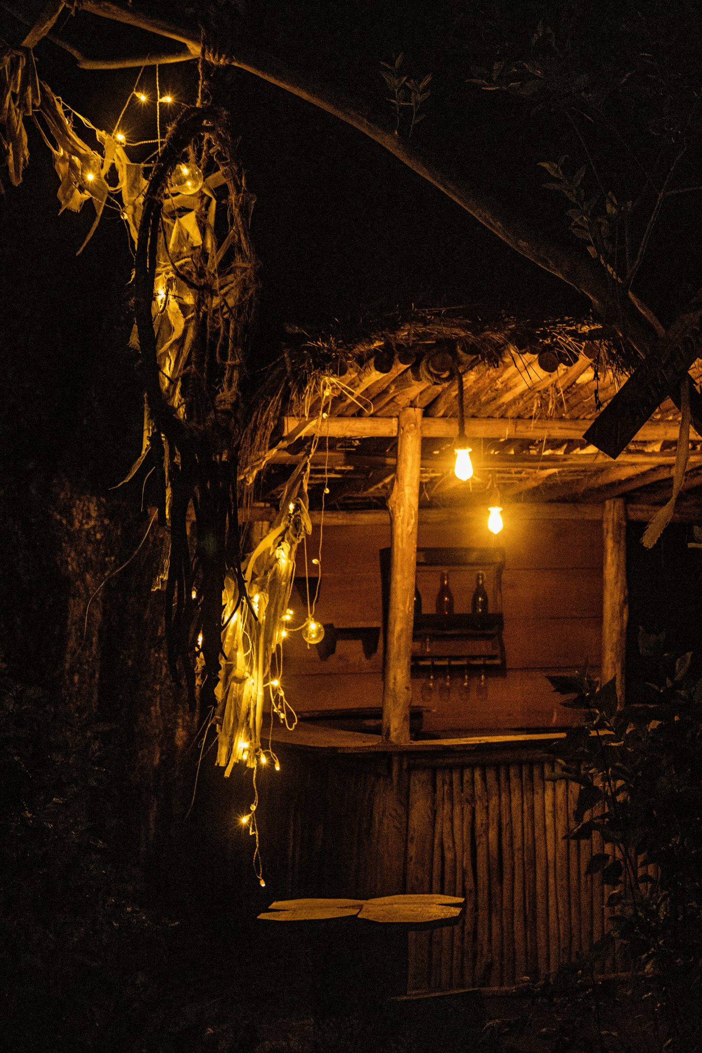 Outdoor bar decorated with string lights at night
