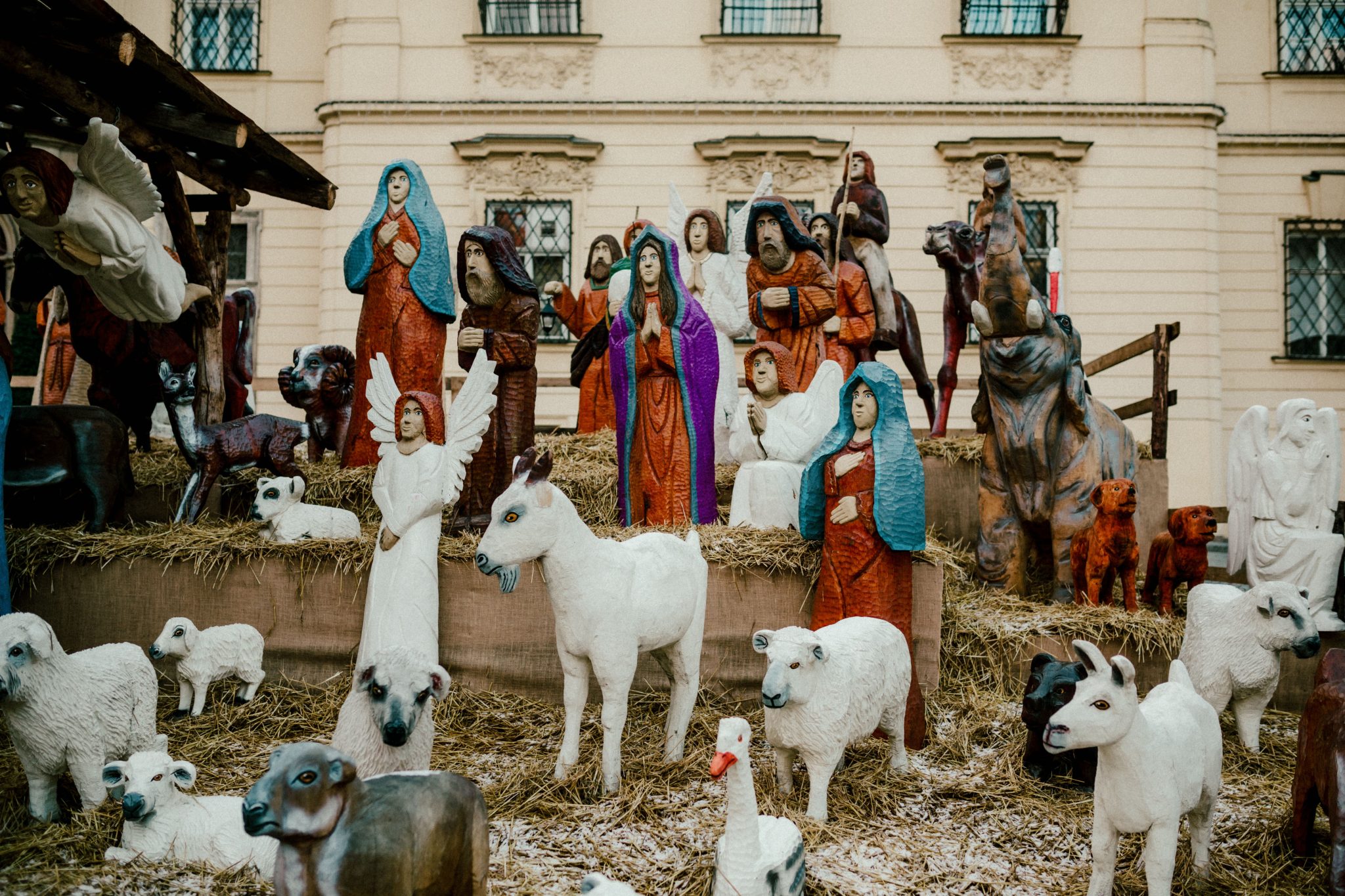 Outdoor display of a traditional Christmas nativity scene with figurines depicting the birth of Jesus.