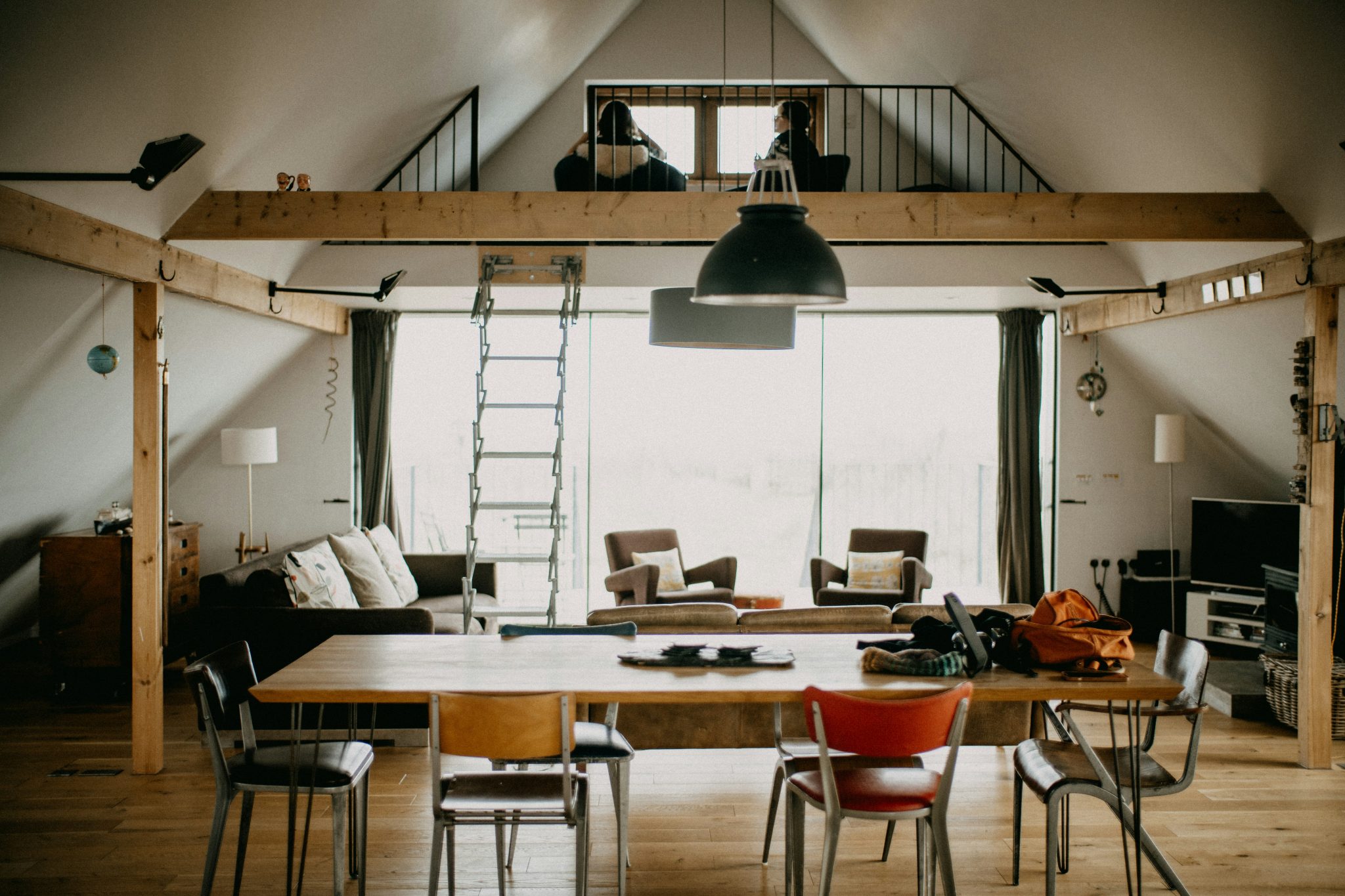 People working in a spacious loft with a large table