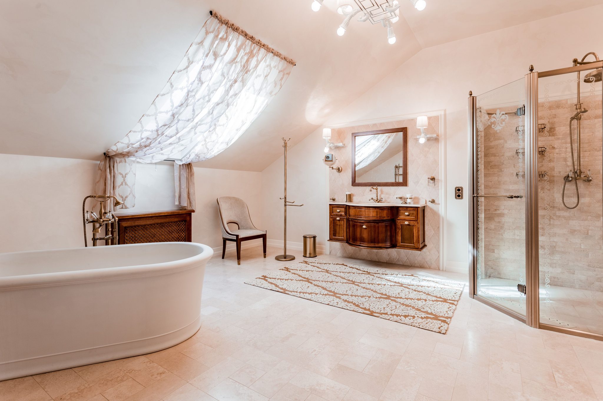 Spacious and elegant attic bathroom featuring a freestanding tub and glass shower.