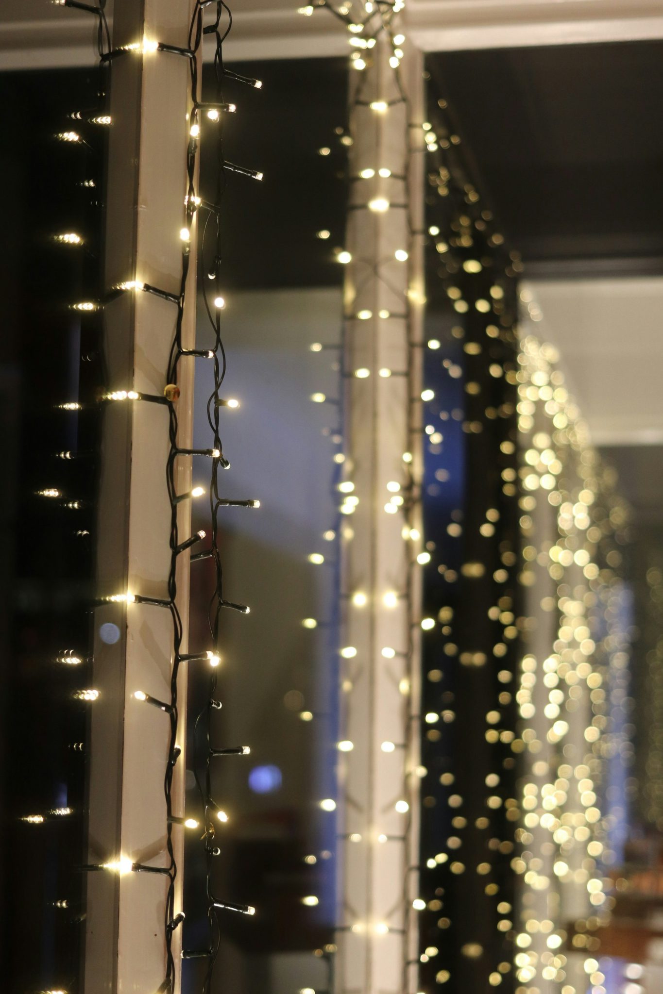 Strings of warm white fairy lights illuminating a dark background