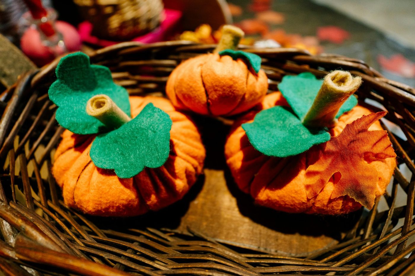 a basket filled with small pumpkins sitting on top of a table
