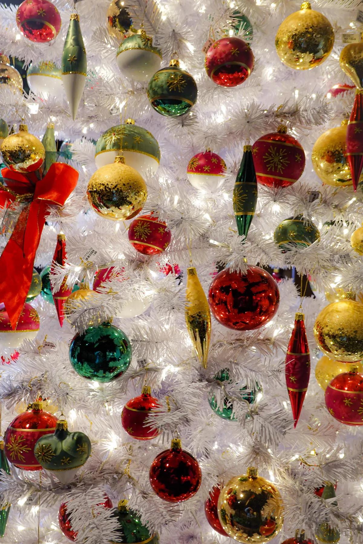 A beautifully decorated Christmas tree with vibrant ornaments and shimmering lights.