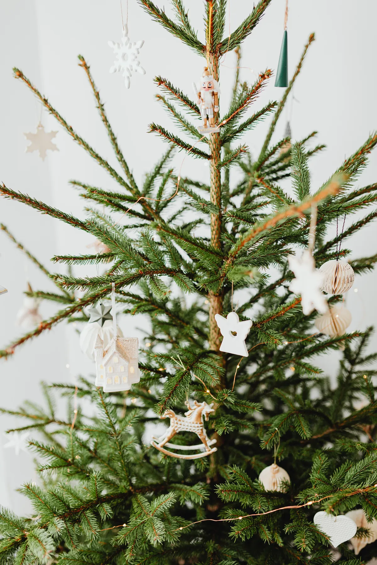 A beautifully decorated Christmas tree with minimalist wooden ornaments for the holiday season.
