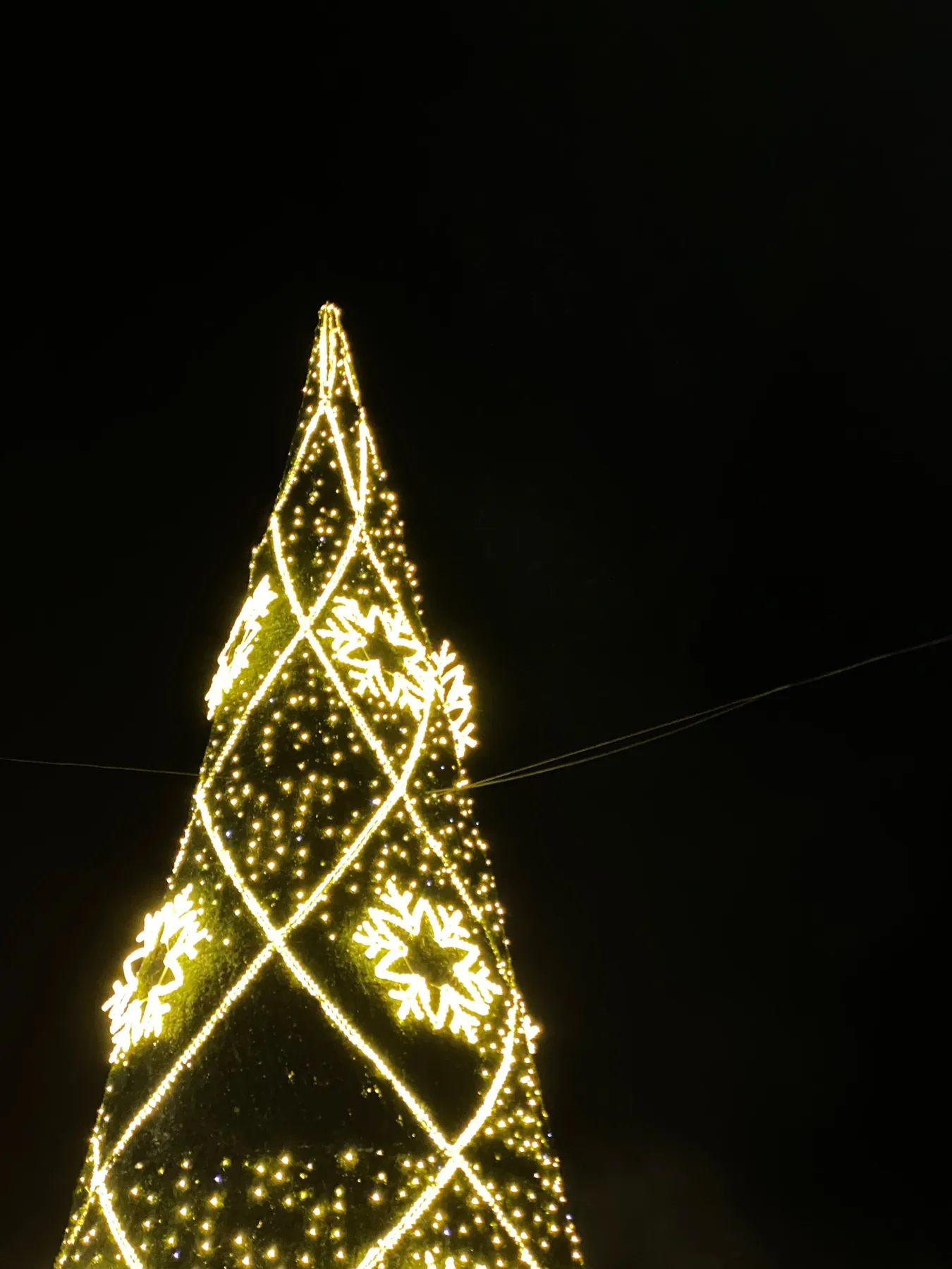 A beautifully illuminated Christmas tree in Cascais, Lisbon, during the night.