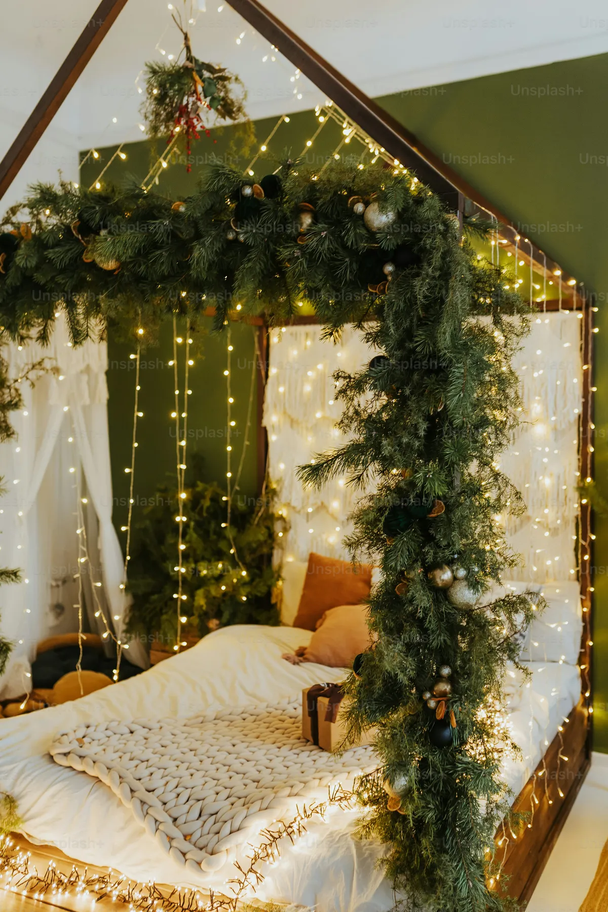 A bed with a canopy covered in christmas lights - Photo on Unsplash+