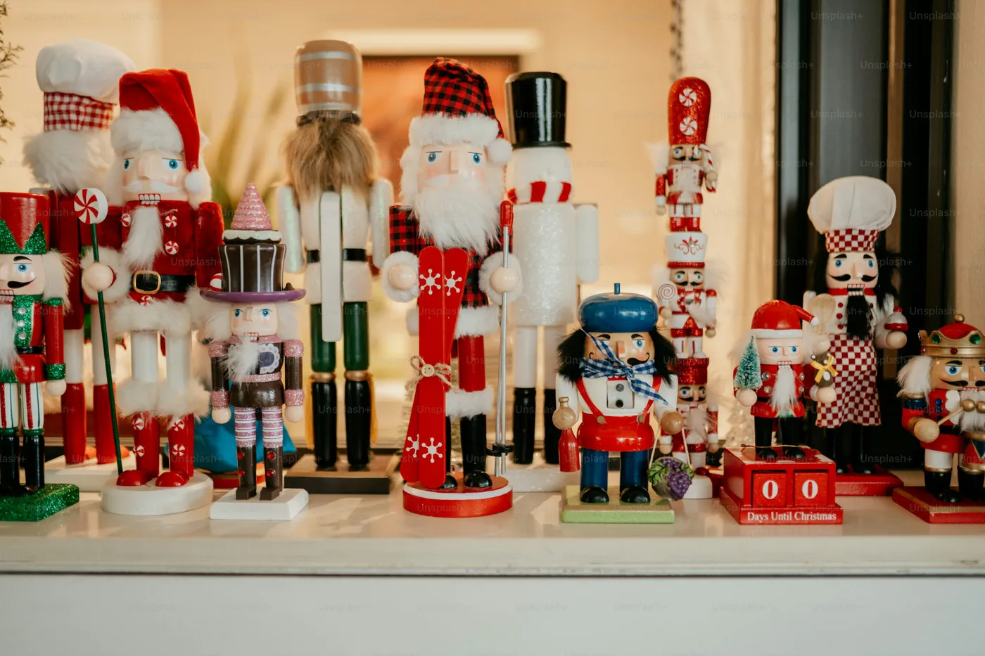 A collection of nutcrackers and figurines on a shelf - Photo on Unsplash+