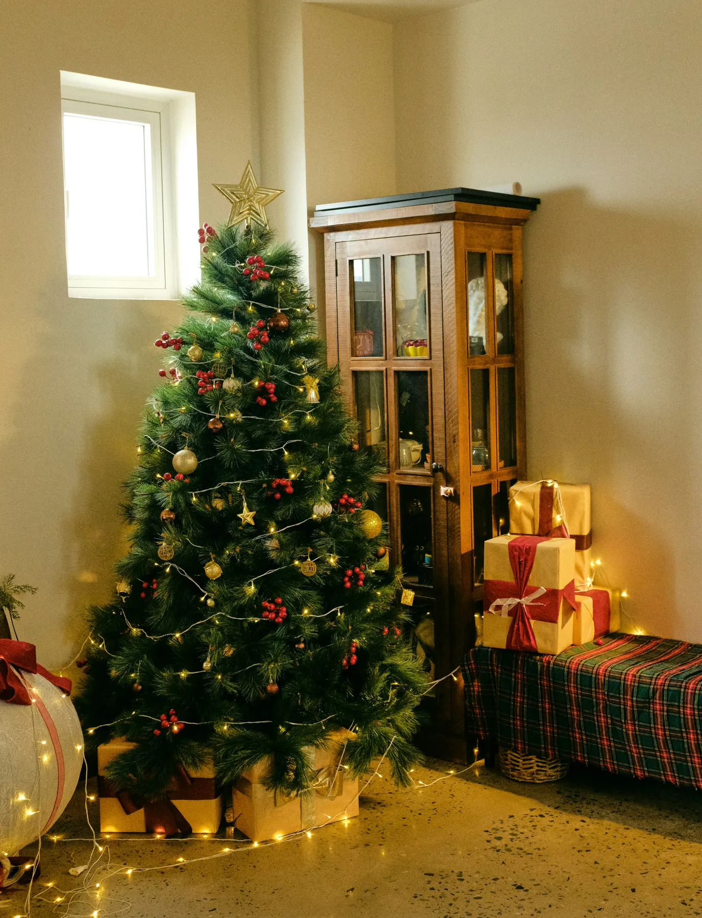 A decorated christmas tree with presents and lights