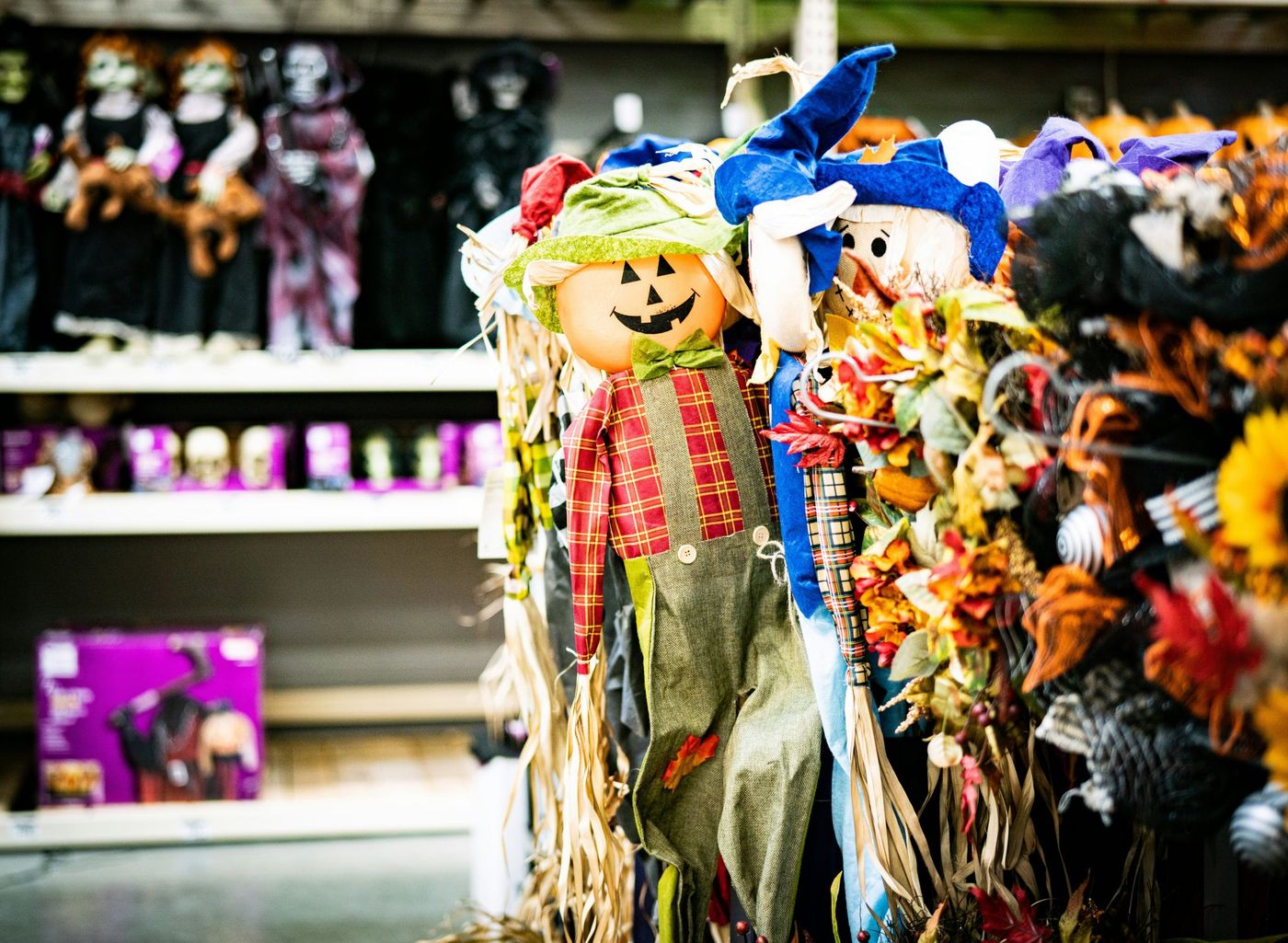 a display of scarecrows and pumpkins in a store