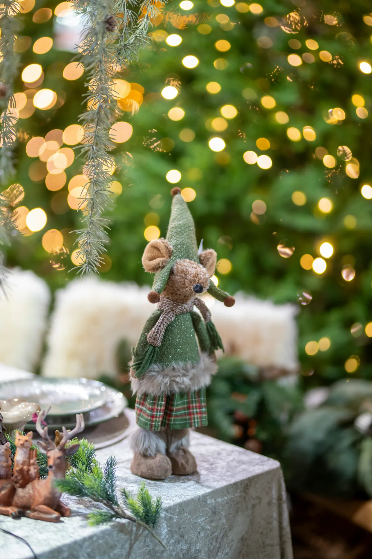 A festive mouse decoration with christmas tree lights