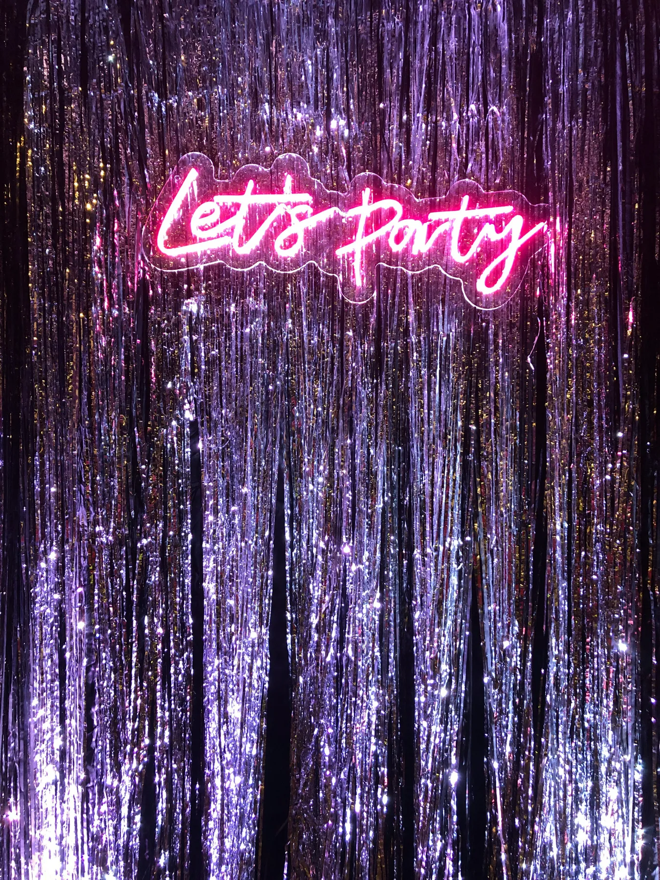 a neon sign that says let's party on it