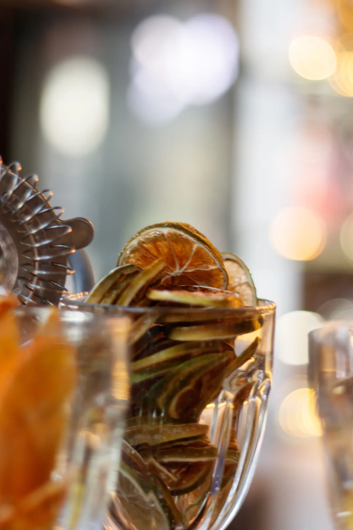 Aesthetic arrangement of dried citrus slices in a glass, perfect for cocktails and home decor.